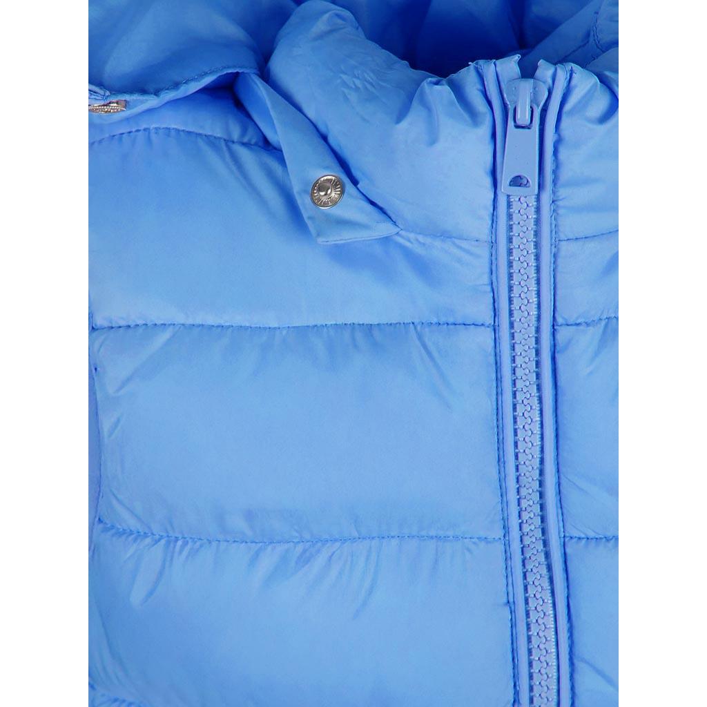 Close-up detail of light blue quilted gilet showing front zip, quilted texture, and snap button on chest pocket area