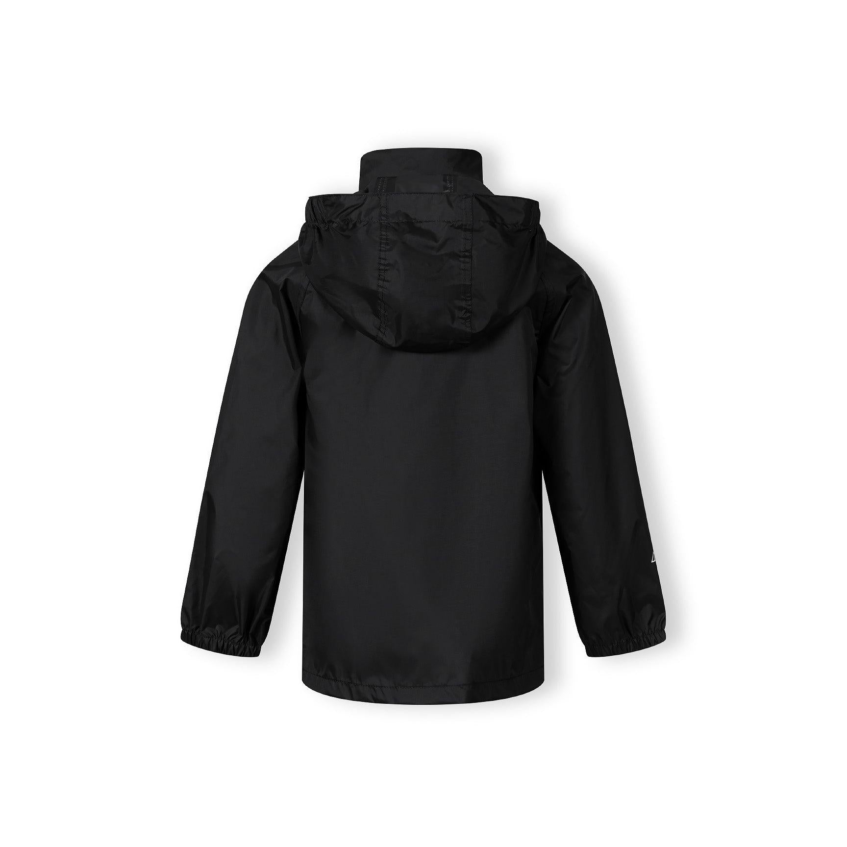 Boy in black hooded waterproof jacket pointing forward, wearing light blue cargo jeans and black sneakers on white studio background