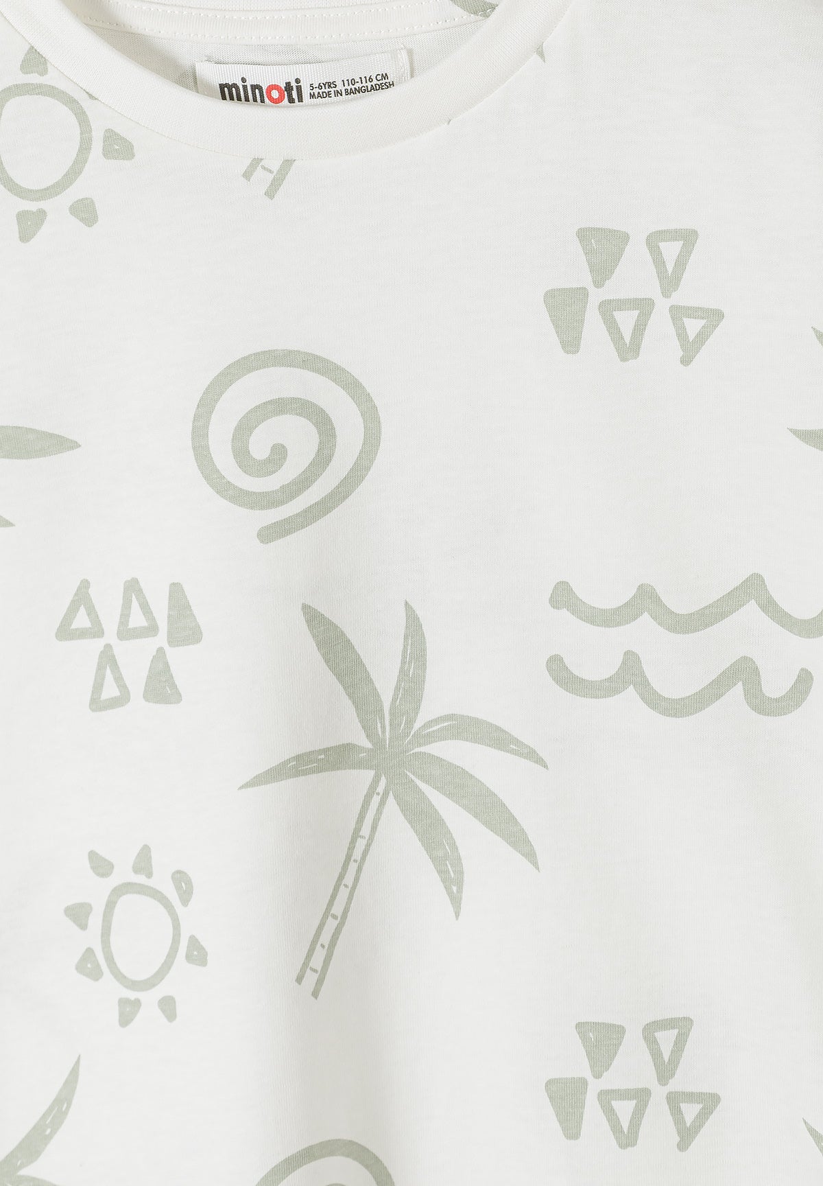 Close-up detail of white t-shirt showing palm tree and geometric pattern print with sun, waves, triangular shapes and spiral motifs in sage green color