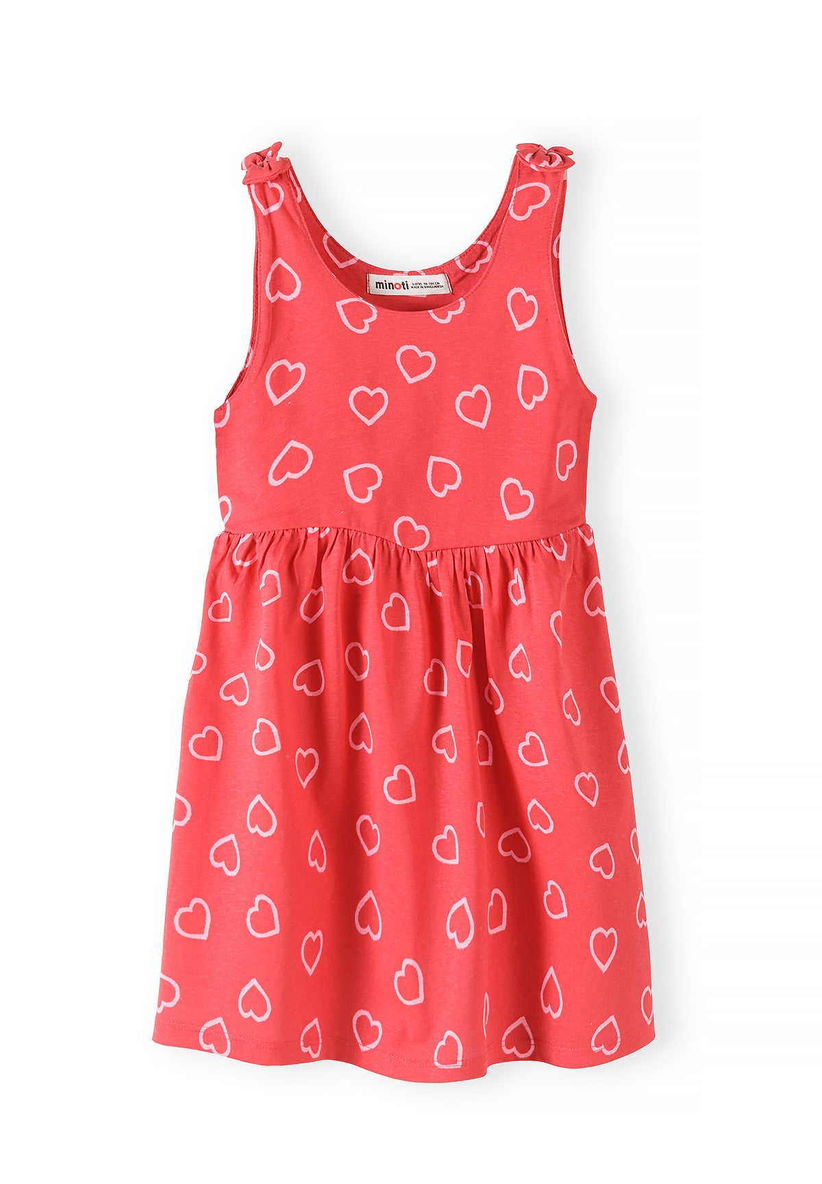 Close-up of coral sleeveless dress with white heart print pattern, showing gathered skirt and tie shoulder straps on white background