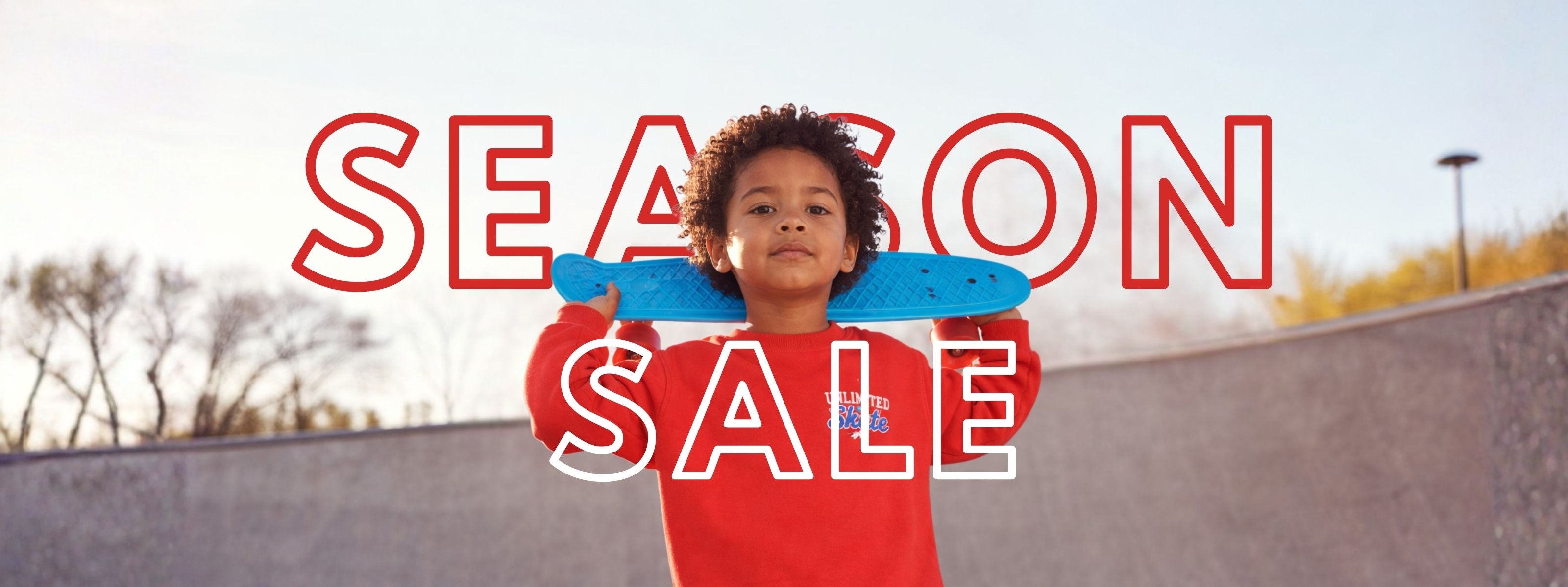 Boy holding a blue skatebord with 'SEASON SALE' text overlay outdoors.