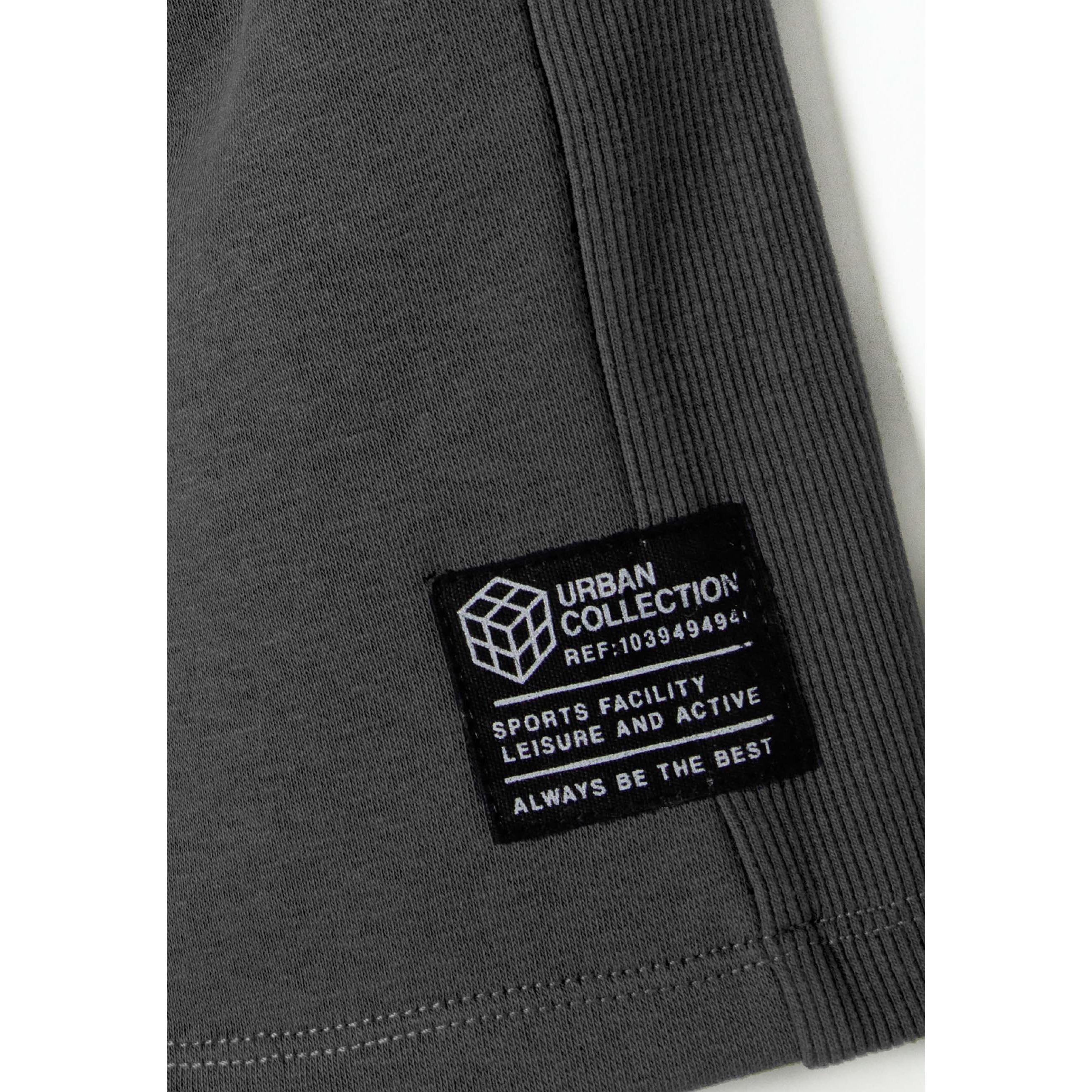 Close-up detail of grey fleece shorts showing ribbed side panel texture and Urban Collection brand label with geometric logo
