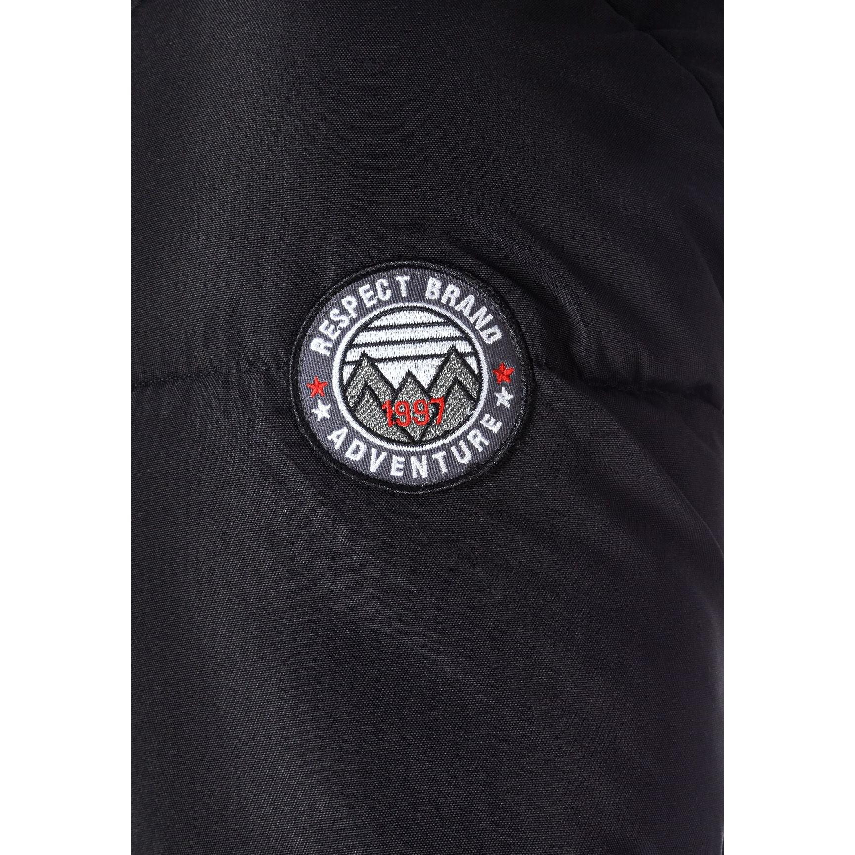 Close-up detail of black jacket showing brown faux fur hood trim, zip closure and quilted padded fabric texture