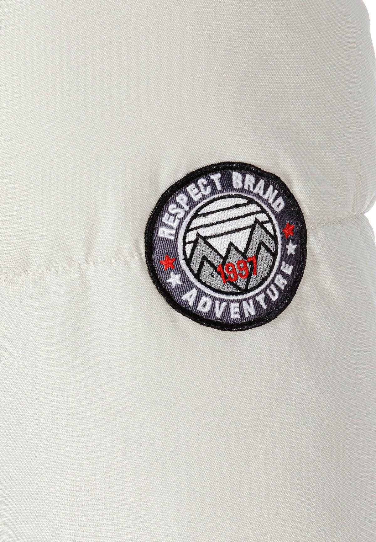 Detail of a men's padded jacket featuring a sleeve badge.