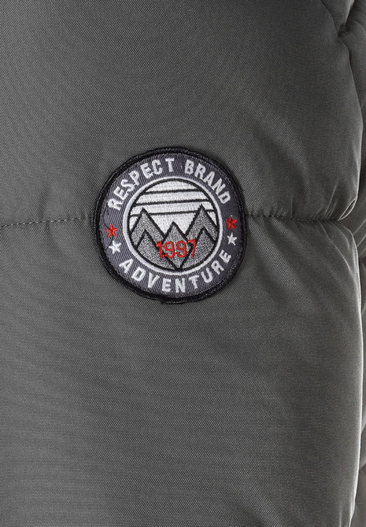 Detail of a grey padded jacket with a logo badge.