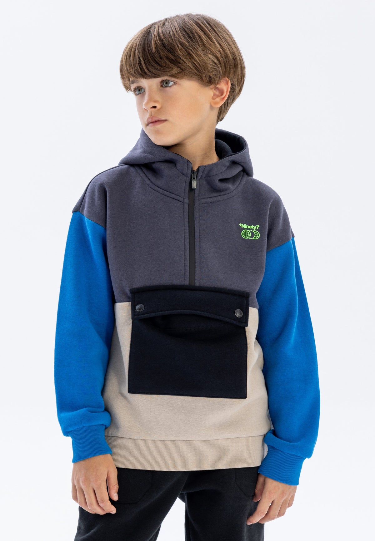 Grey, blue, beige and black colour block quarter-zip hoodie, model front.