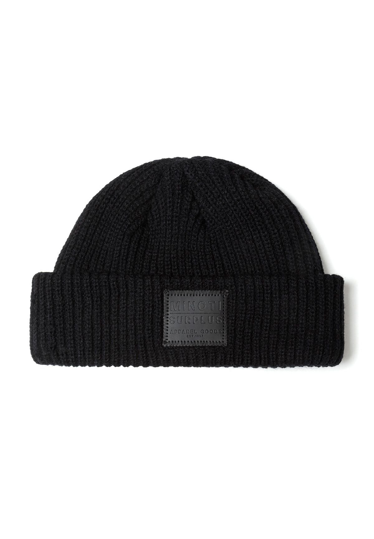 Knitted black fisherman hat with front badge detail, close-up view.