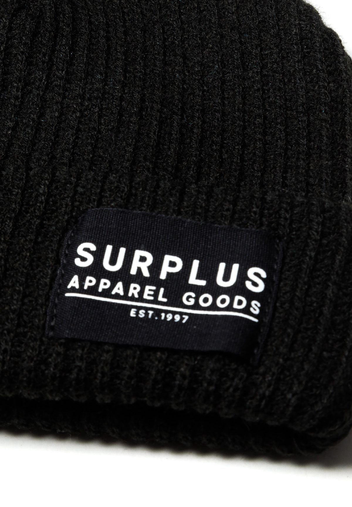 Turquoise and black ribbed beanies, black badge detail.