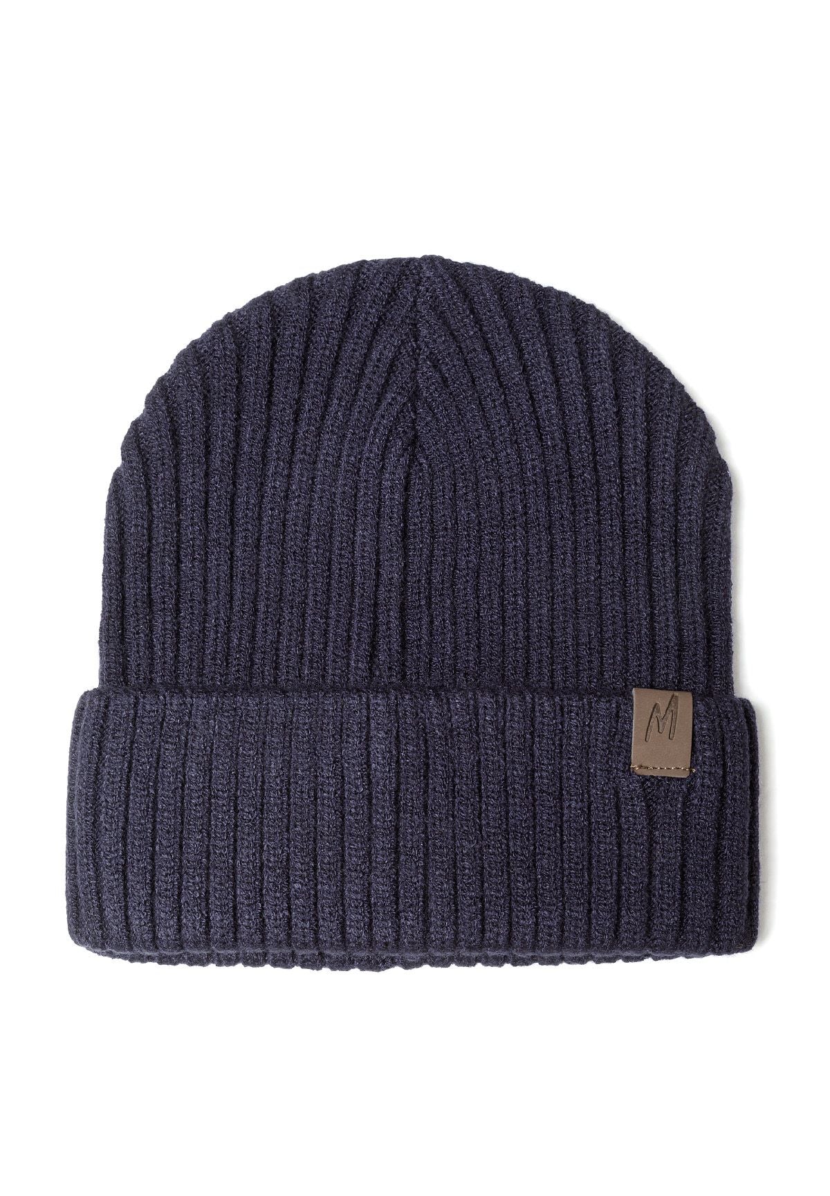 Close-up of a navy ribbed knit hat with cuff and tab detail.