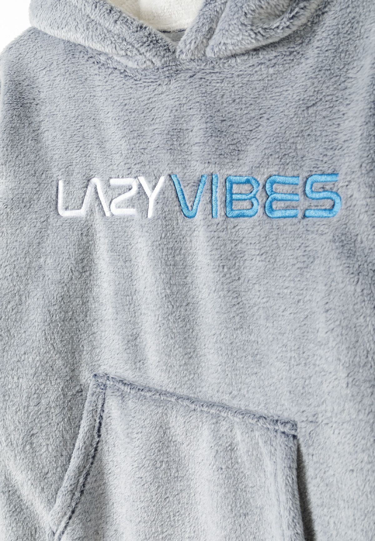 Close-up of raised white and blue LAZY VIBES lettering above grey plush kangaroo pocket.