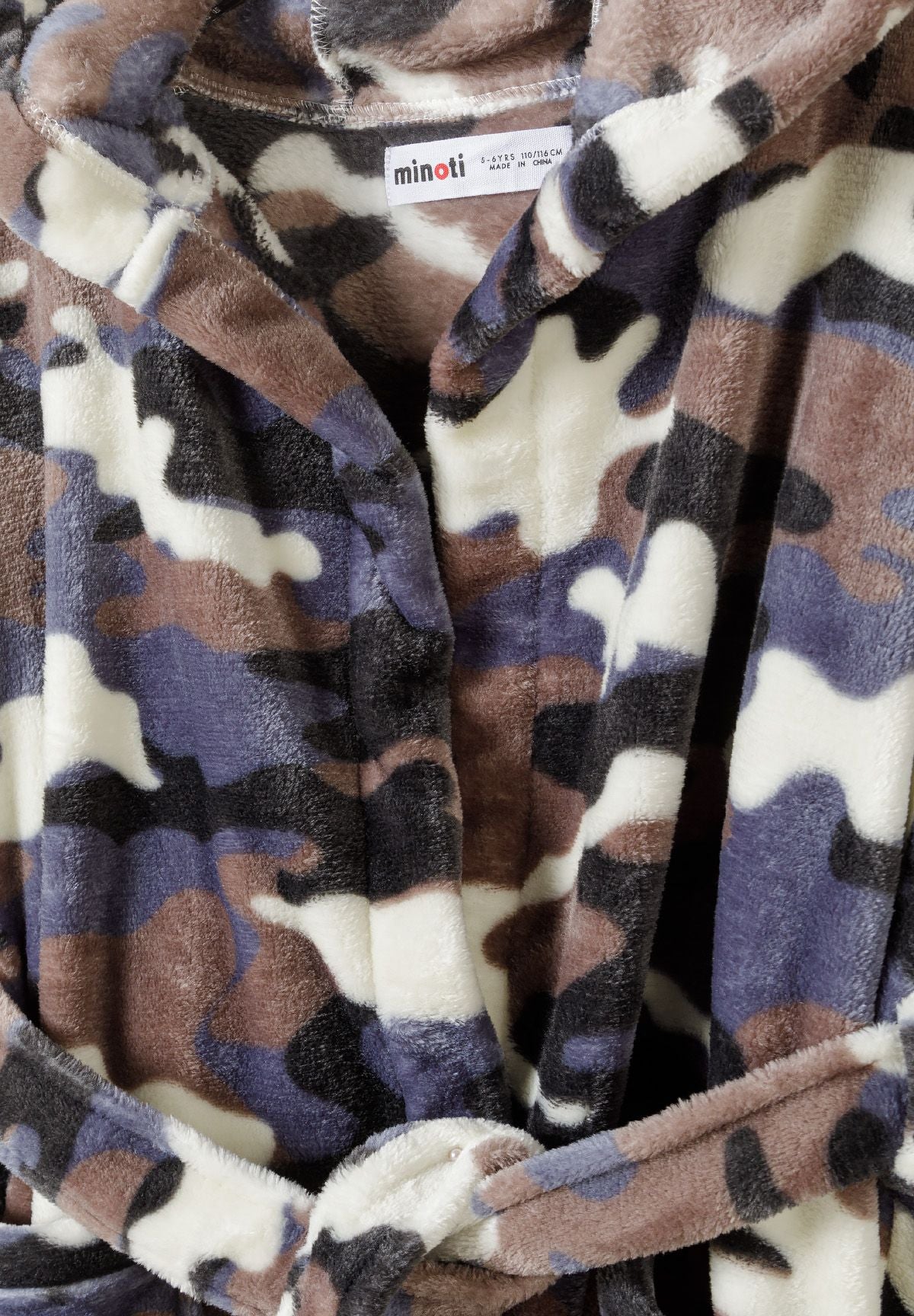 Close-up of a boys' robe in camouflage pattern with a tie belt and collar.