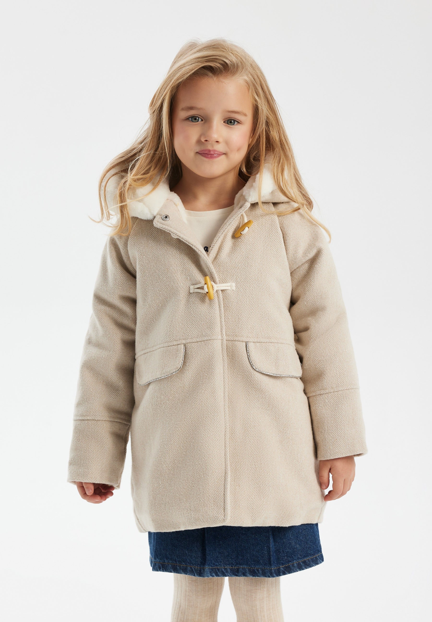 Girls padded jacket in beige with fur-trimmed hood, front view, featuring toggle fastenings and pockets.