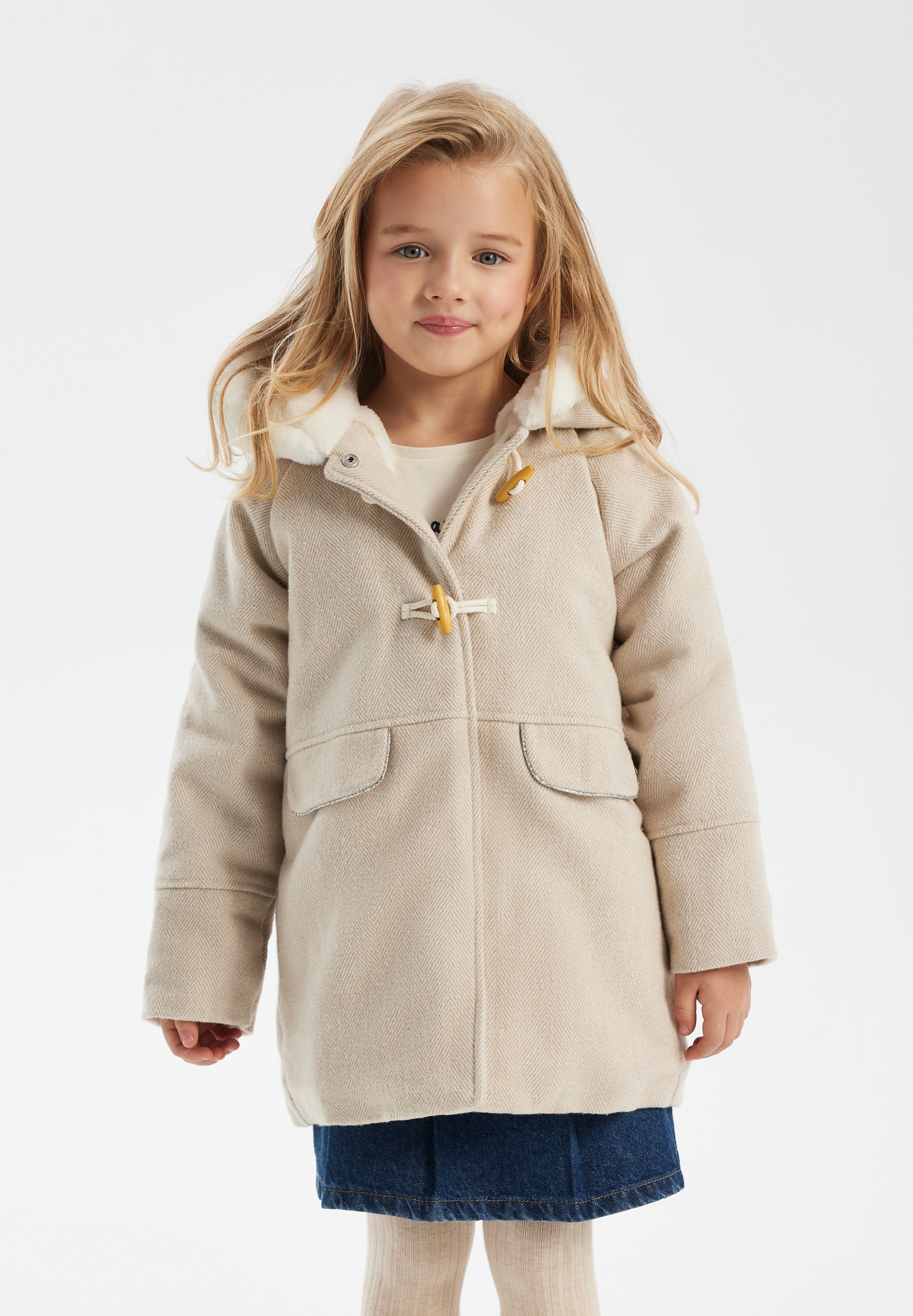 Girls padded jacket in beige with fur-trimmed hood, front view, featuring toggle fastenings and pockets.