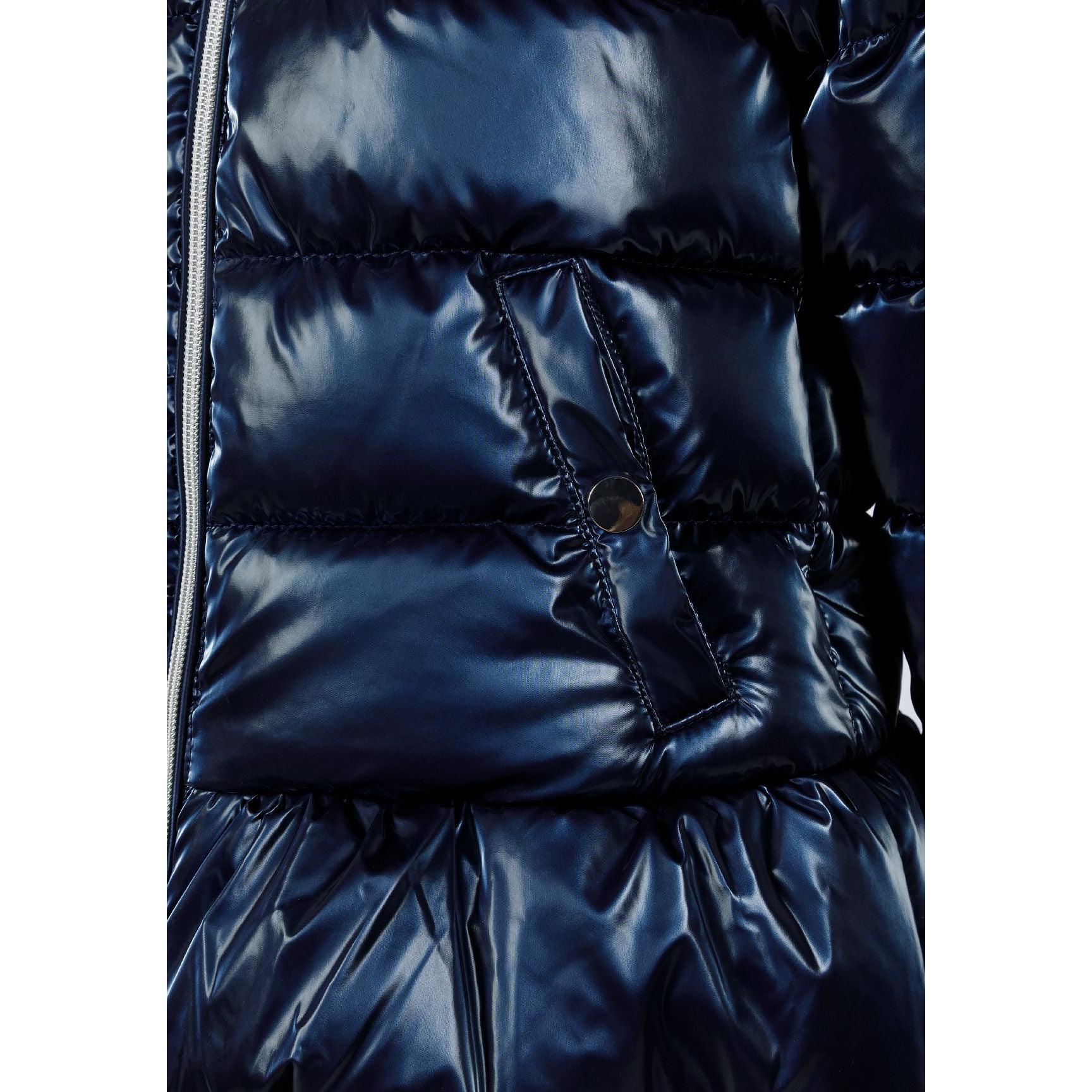 Close-up detail of metallic navy padded jacket showing zip closure, quilted panels, chest pocket and shiny fabric texture