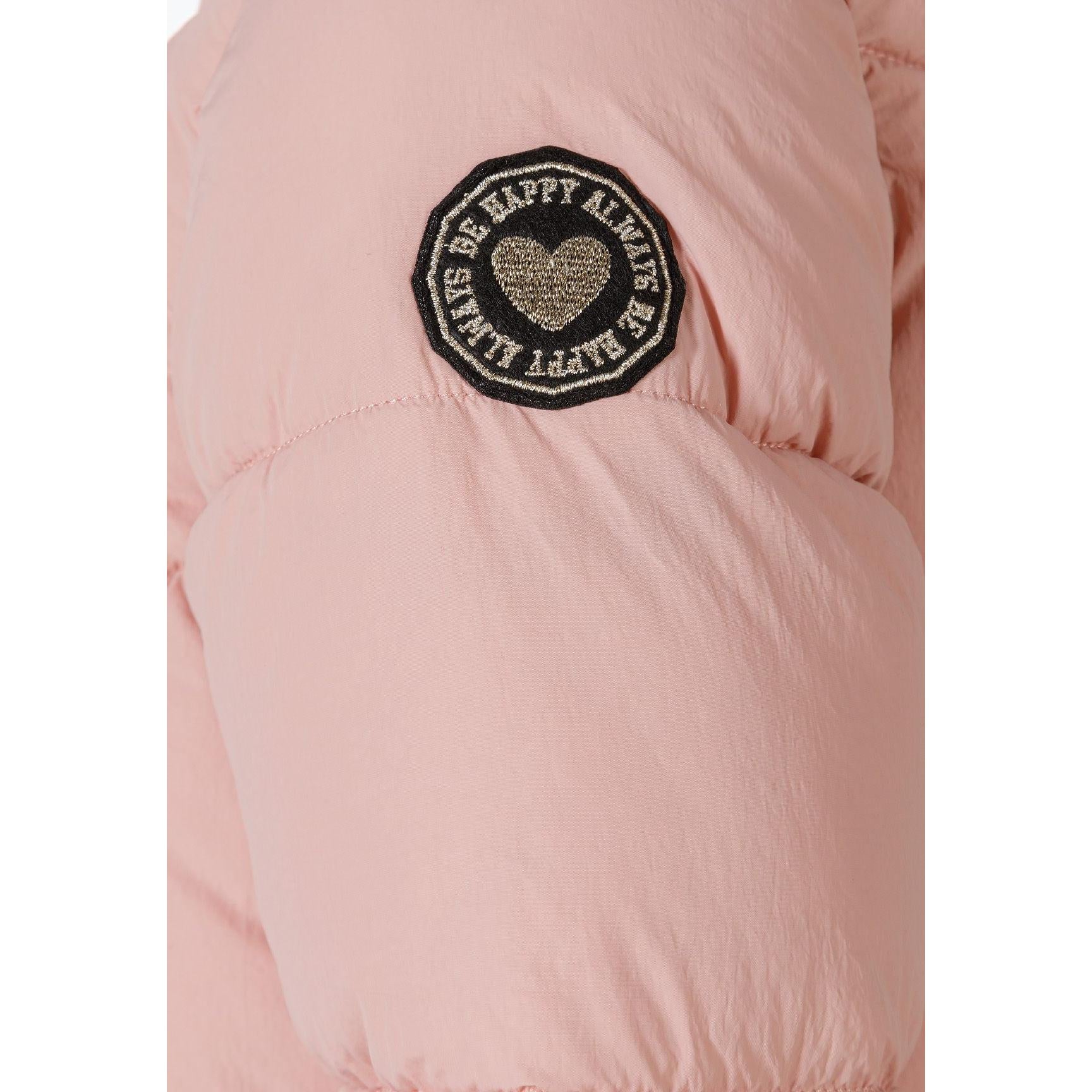 Close-up detail of pink quilted jacket showing side pocket with zip closure and diagonal stitching pattern