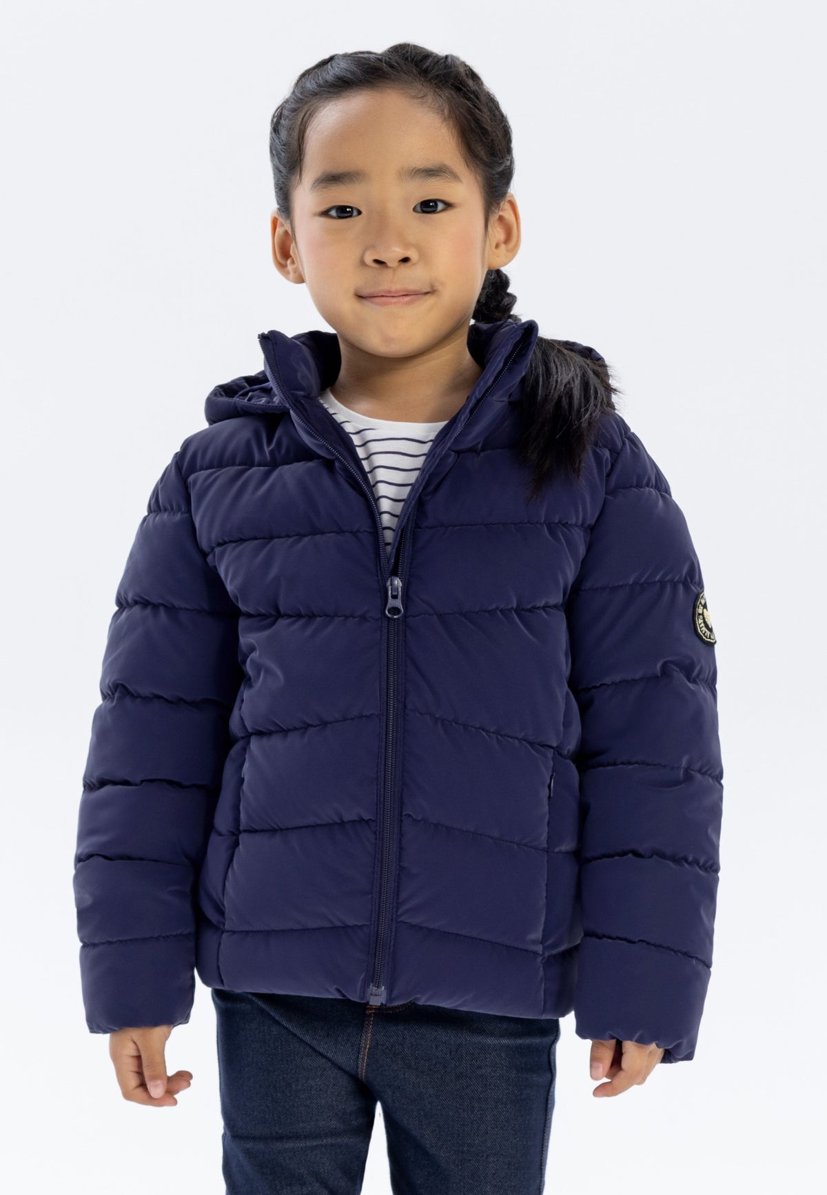 Girls' navy puffer jacket, shown worn.