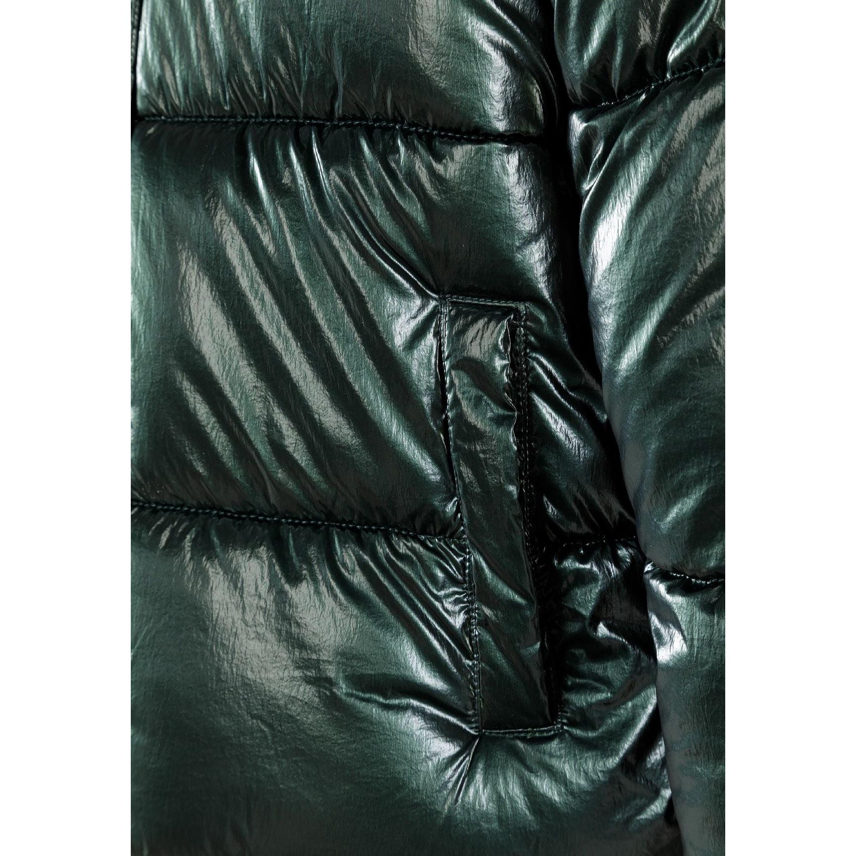 Close-up detail of embroidered circular patch with heart design and text on green metallic jacket fabric