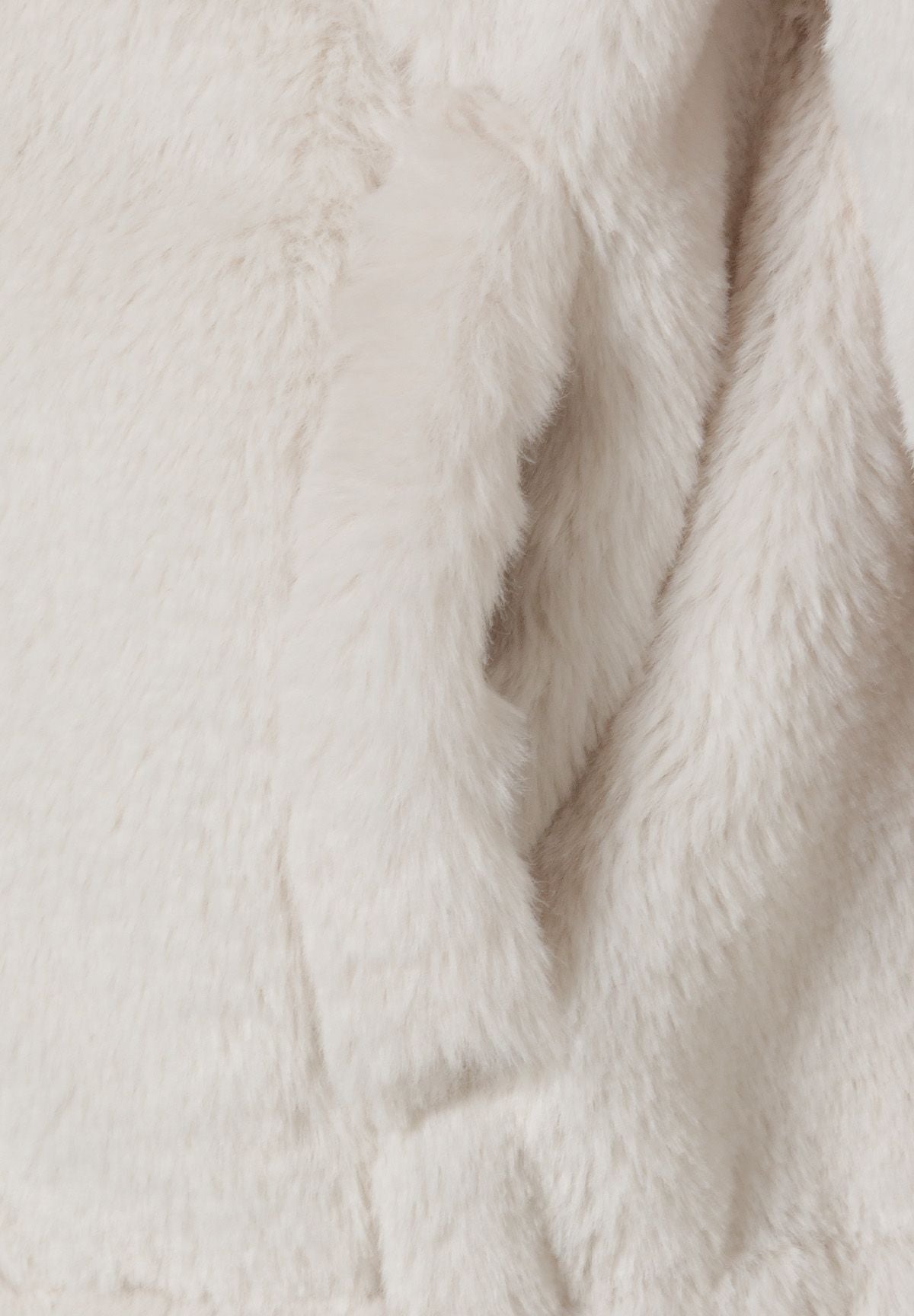 Detail of plush teddy fur in beige, showcasing soft texture.