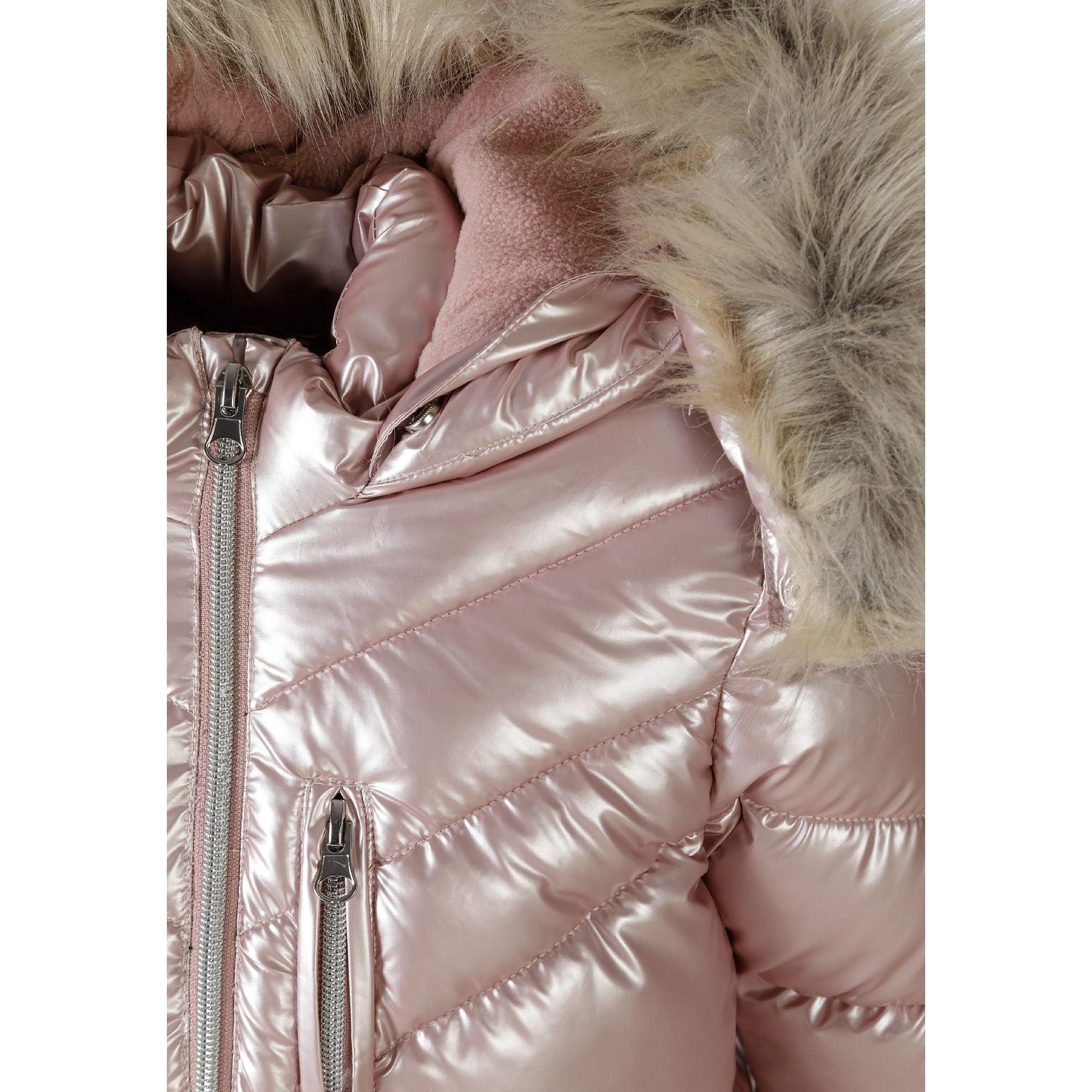 Close-up detail of pink puffer coat showing quilted texture, chest pocket with snap closure and ribbed cuff