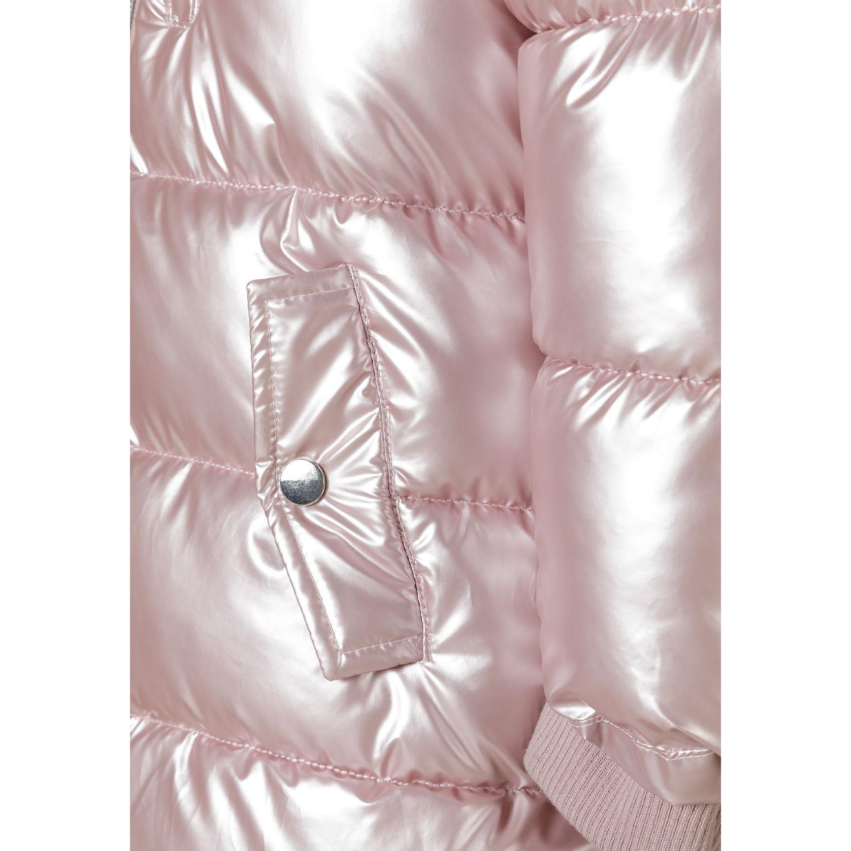 Close-up detail of pink puffer coat showing quilted texture, chest pocket with snap closure and ribbed cuff