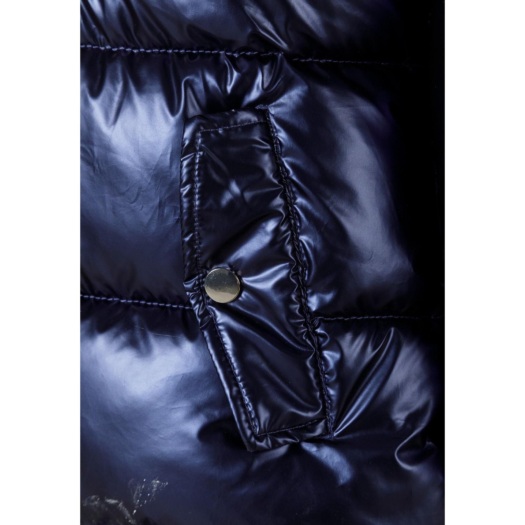 Close-up detail of navy quilted fabric showing textured surface, stitching lines and side pocket with rope drawstring