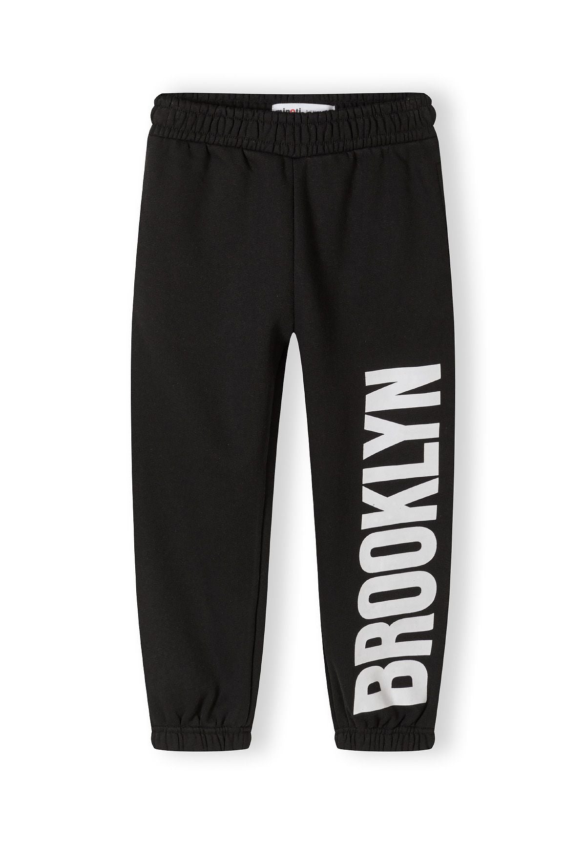 Black girls' tracksuit pants with 'BROOKLYN' print, front view.