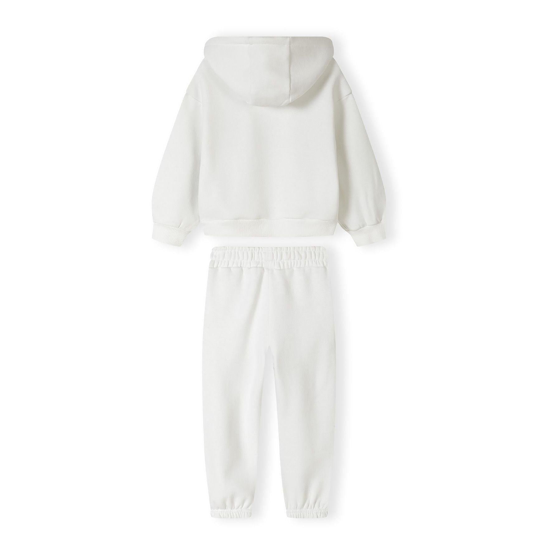 Close-up detail of white joggers showing black printed text on leg and elasticated waistband construction