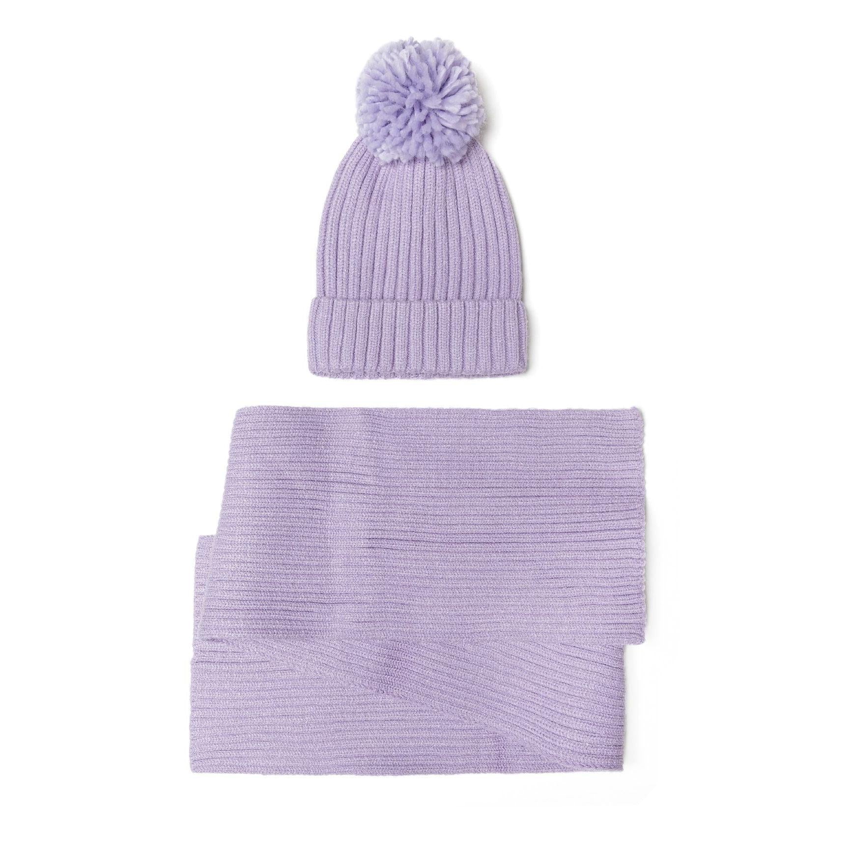 Close-up detail of lilac ribbed knit winter hat showing fluffy pom pom texture and vertical ribbed knit pattern