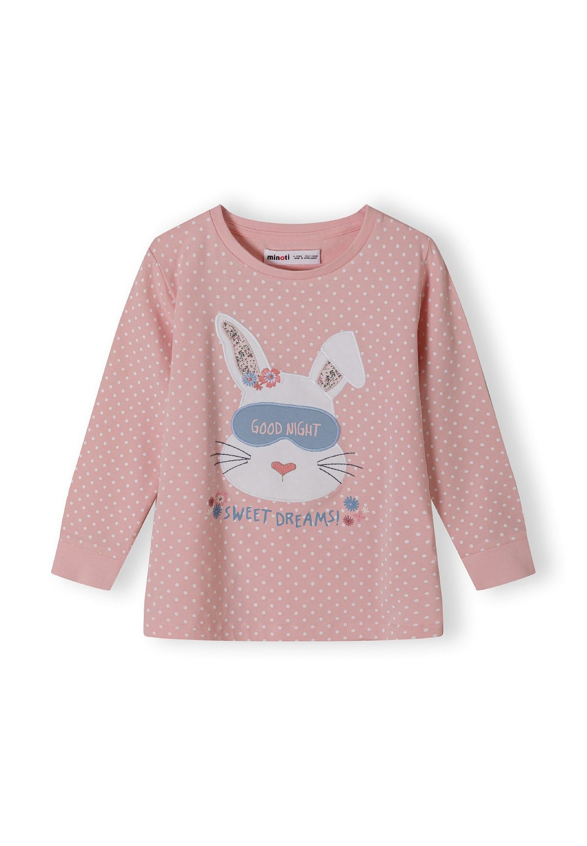 Detail of a pink long sleeve pajama top with polka dots and a bunny graphic.