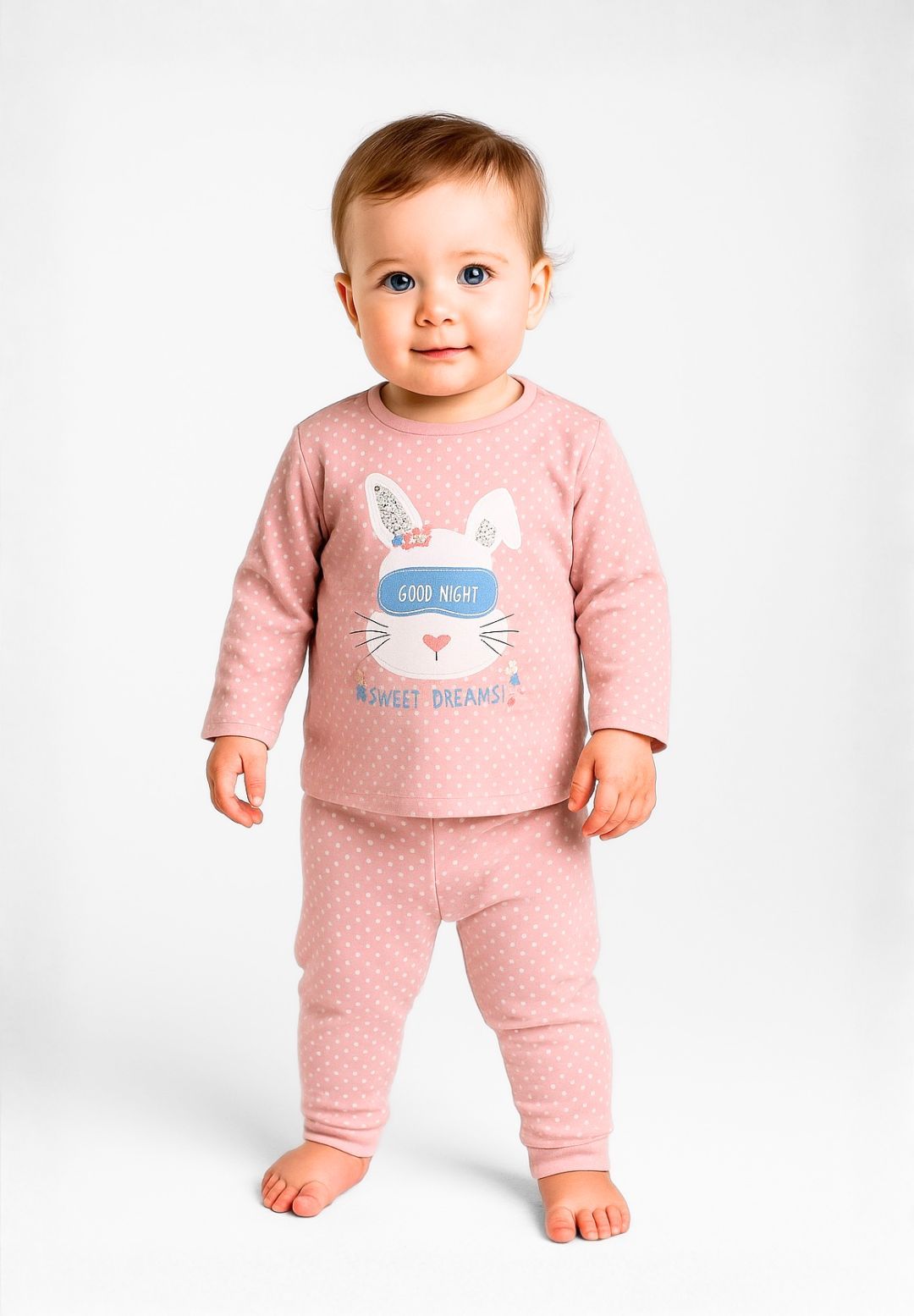 Girls long sleeve pyjamas set in pink with polka dots, featuring a bunny graphic and ribbed cuffs.