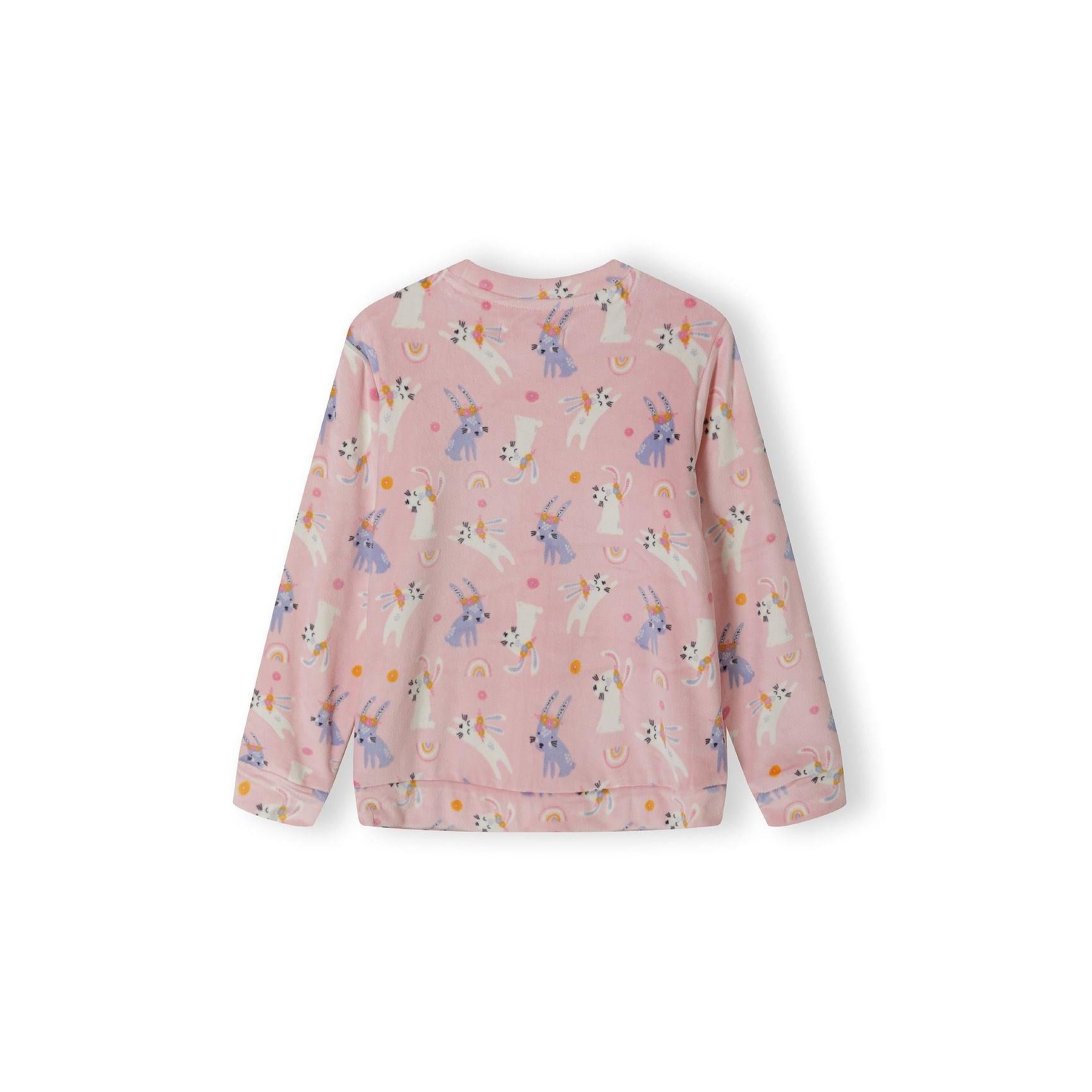 Pink velour pyjama top laid flat showing unicorn pattern and long sleeves on white background