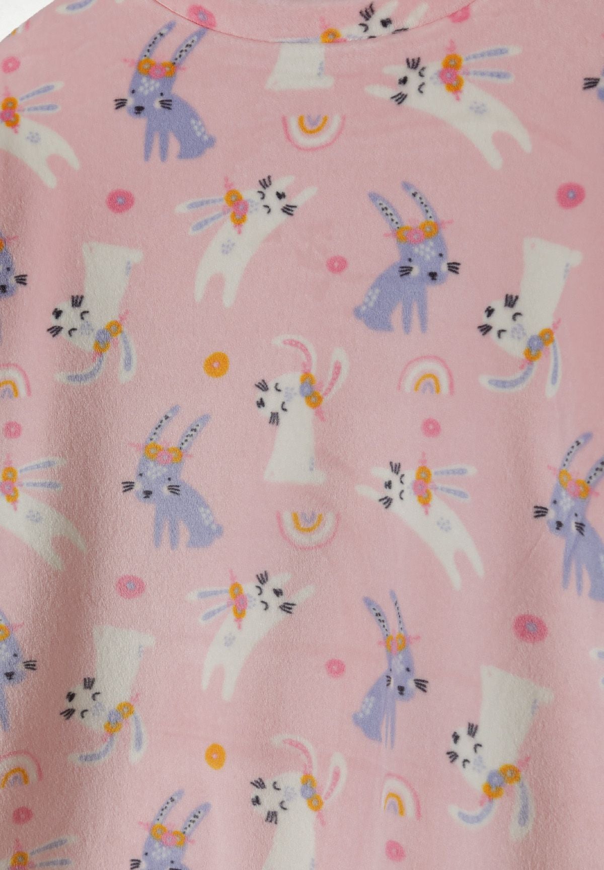 Detail of girls' pink velour pyjama top with bunny print.