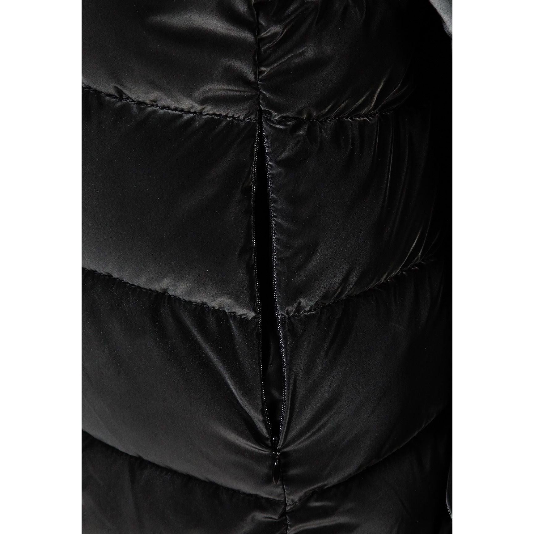 Close-up detail of black quilted fabric showing texture and zip fastening