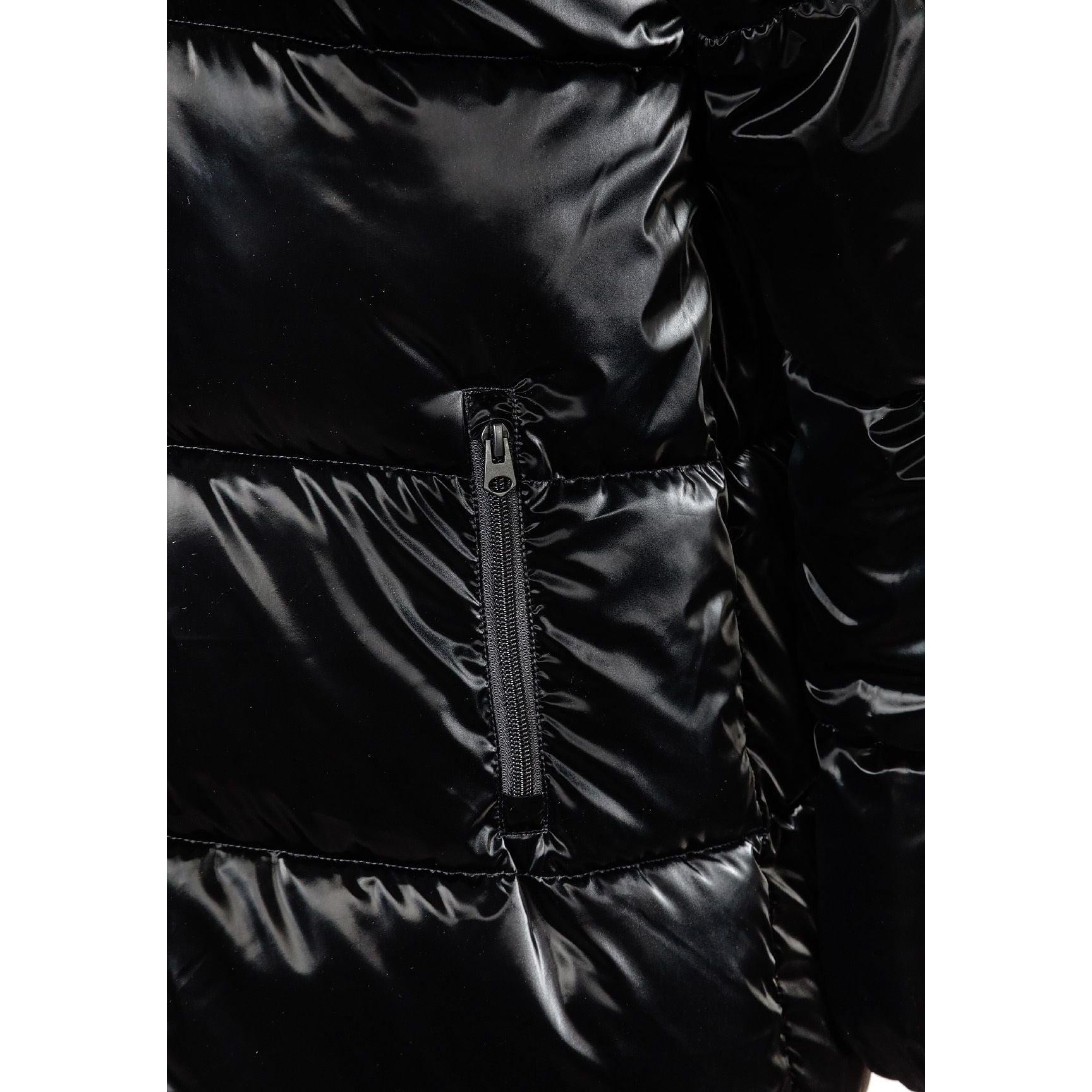Close-up detail of black puffer jacket showing quilted texture and zip closure