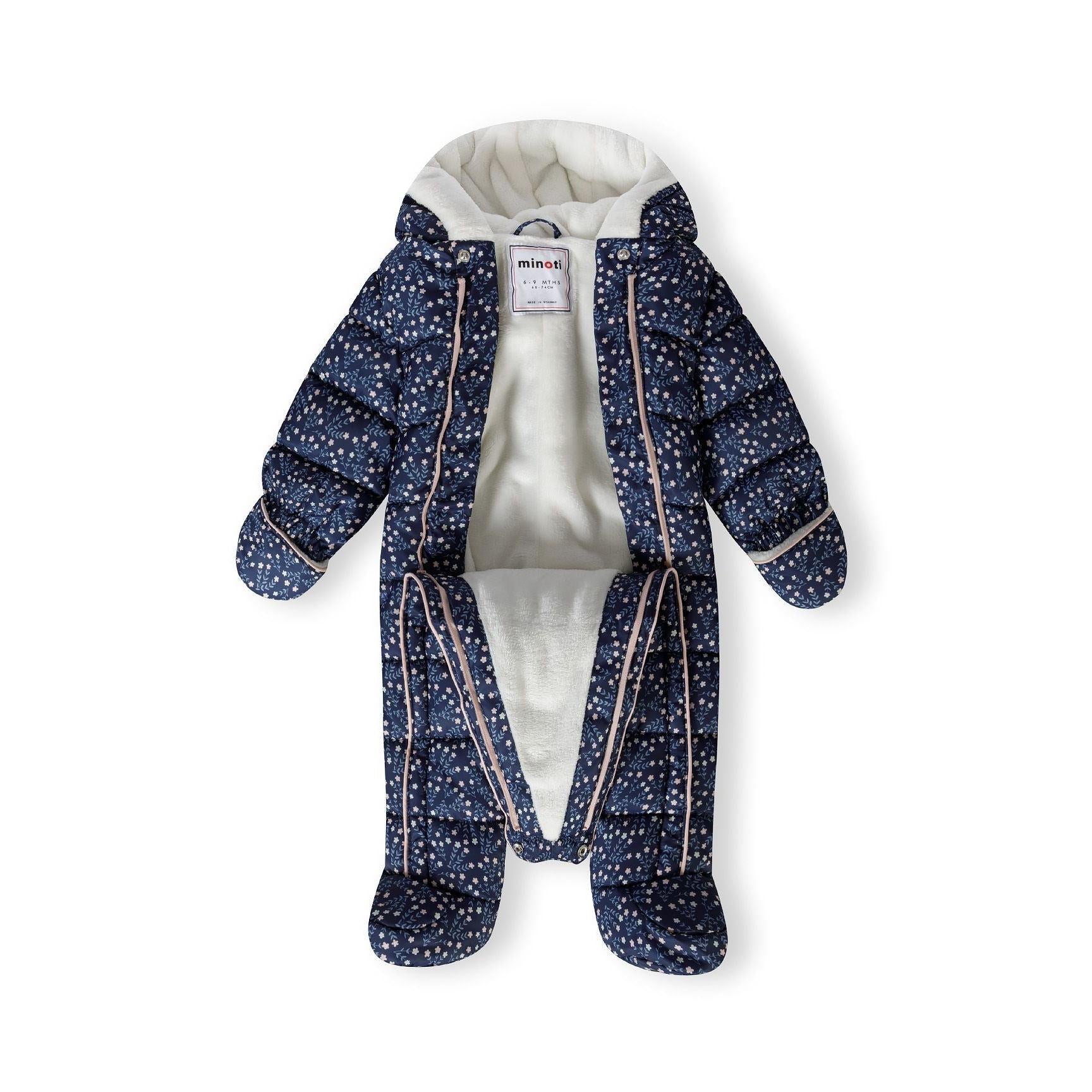 Navy floral snowsuit laid flat showing full zip closure, attached mittens, and cream hood lining with Minoti label visible
