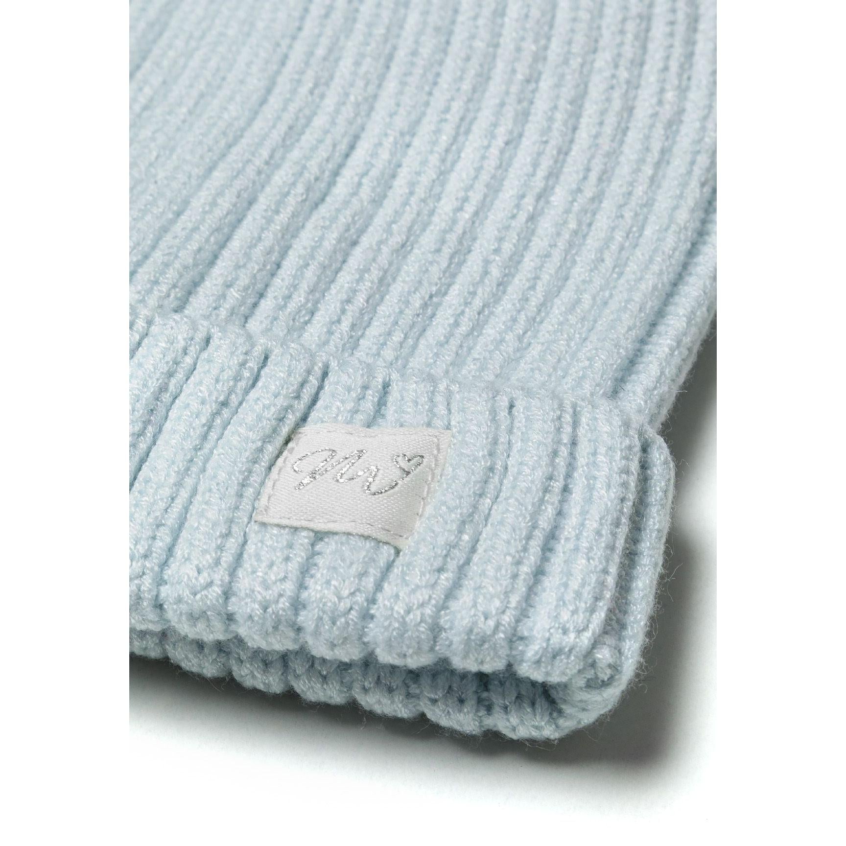 Close-up detail of light blue ribbed beanie showing texture and white lurex Minoti badge on folded brim
