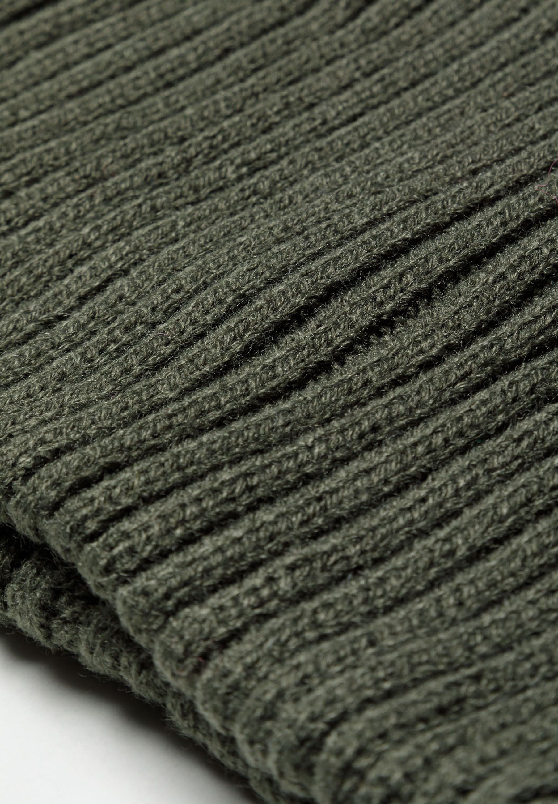 Detail of a knitted ribbed snood in khaki, showcasing a textured design.