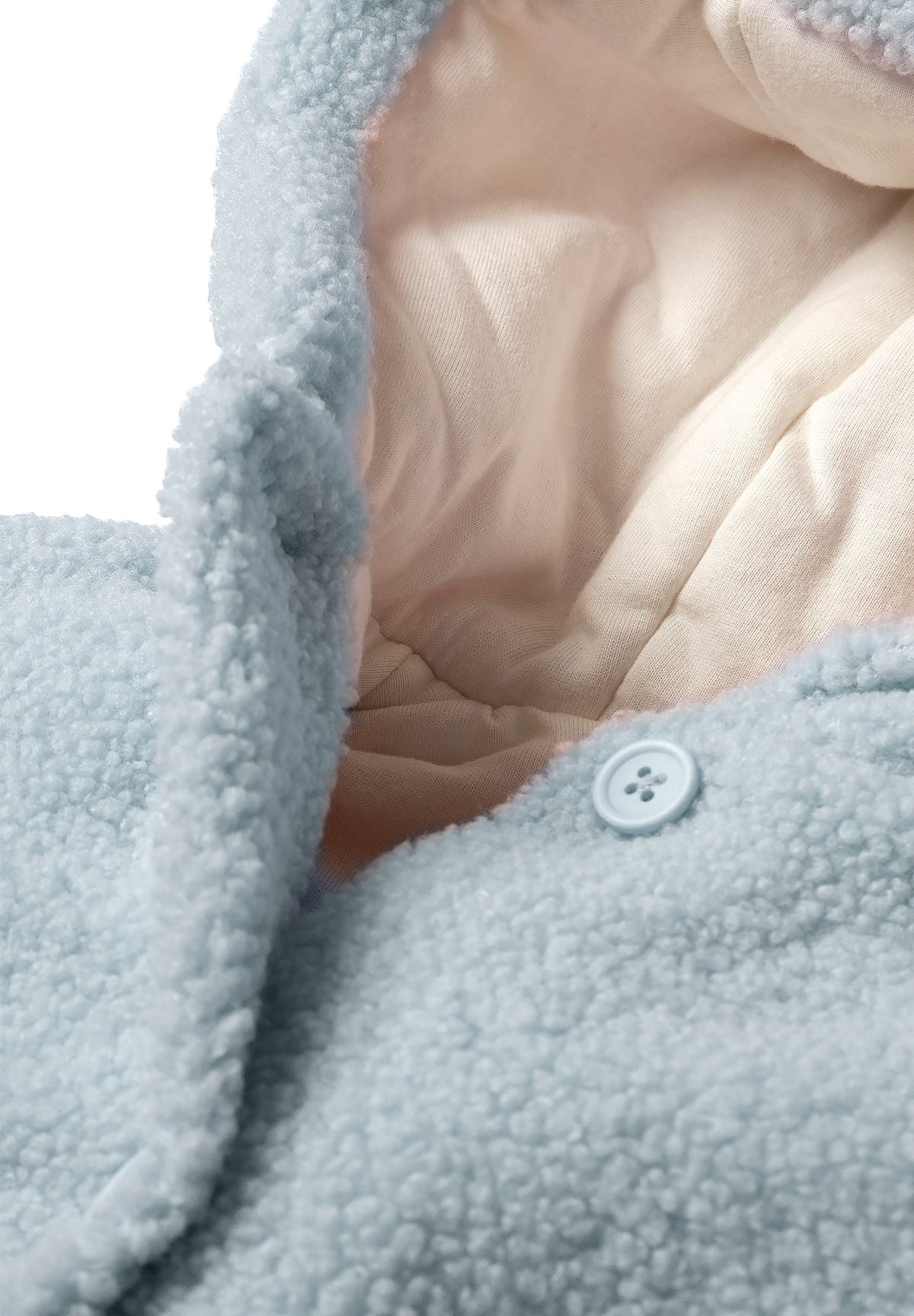 Detail of a light blue teddy baby jacket with hood and button closure.