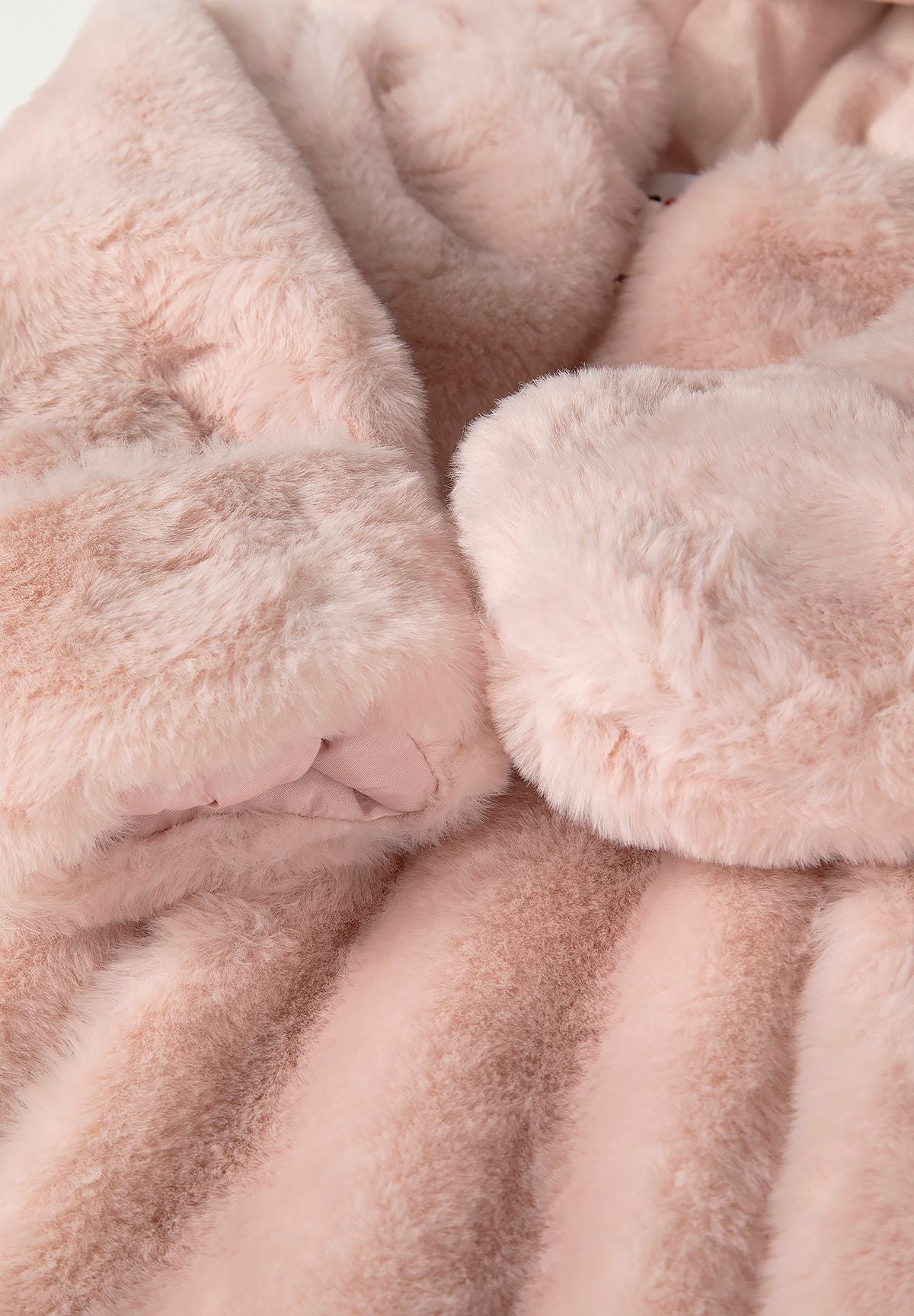Detail of light pink faux fur snowsuit with soft texture and elasticated cuffs.