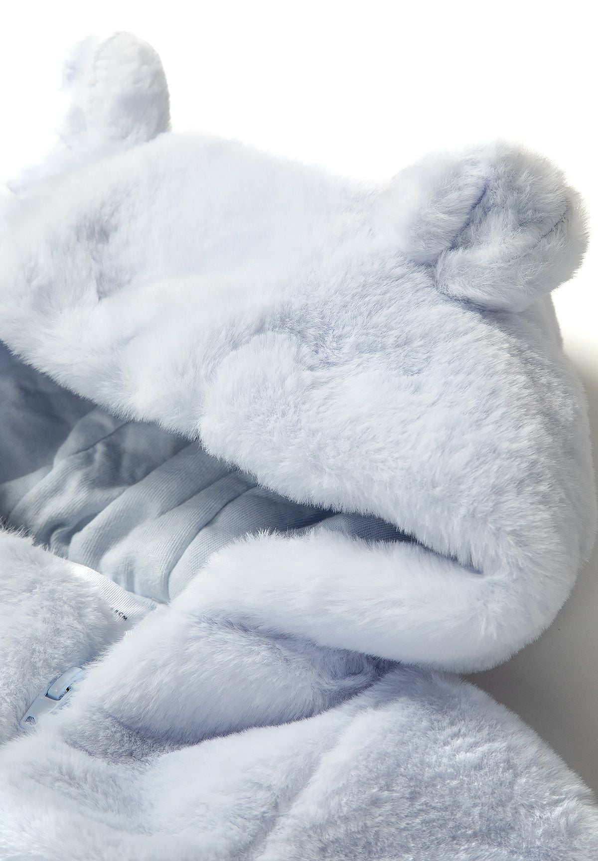 Close-up of light blue boys snowsuit hood with 3D ears and soft faux fur.