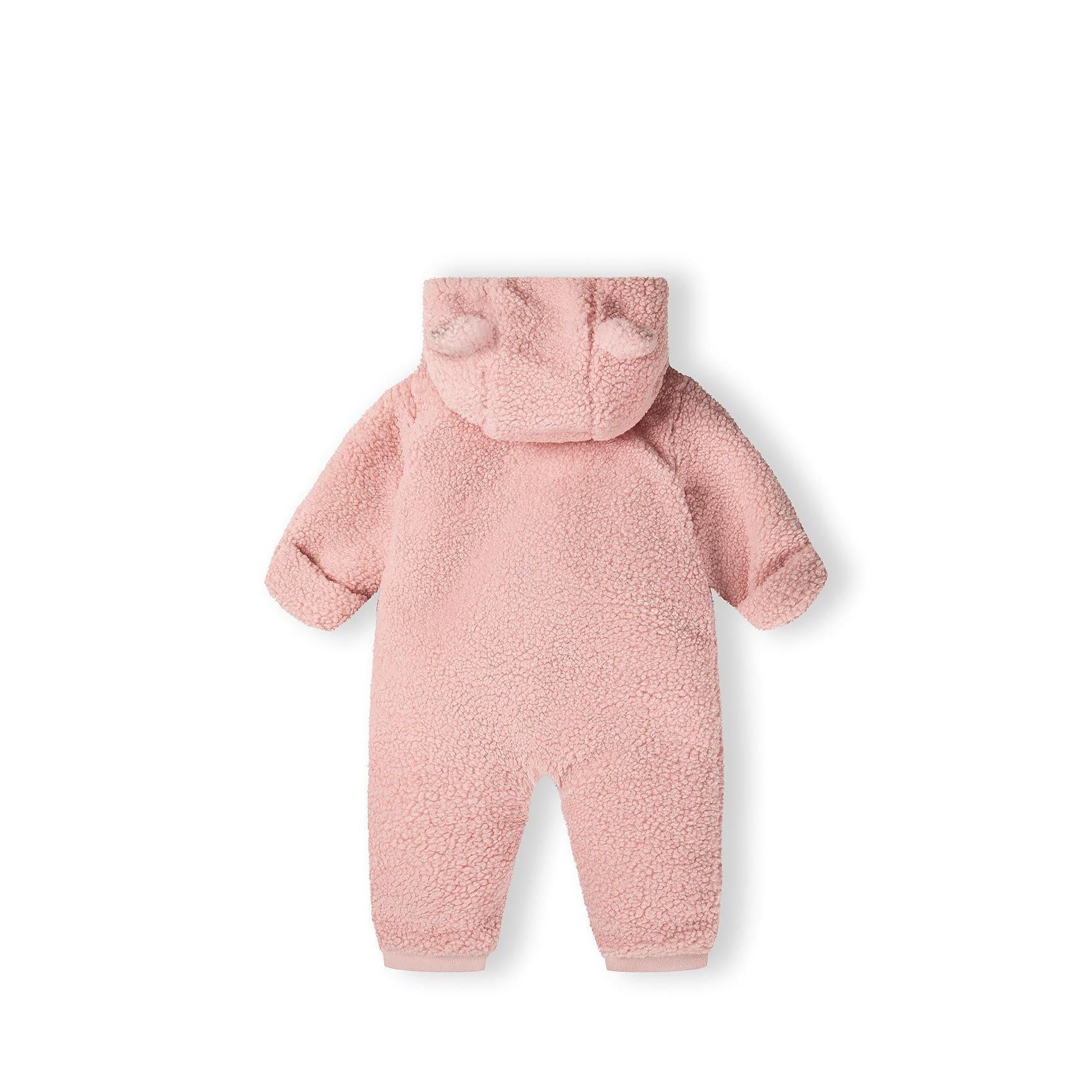 Close-up interior view showing cream jersey cotton lining and Minoti brand label inside the pink sherpa snowsuit