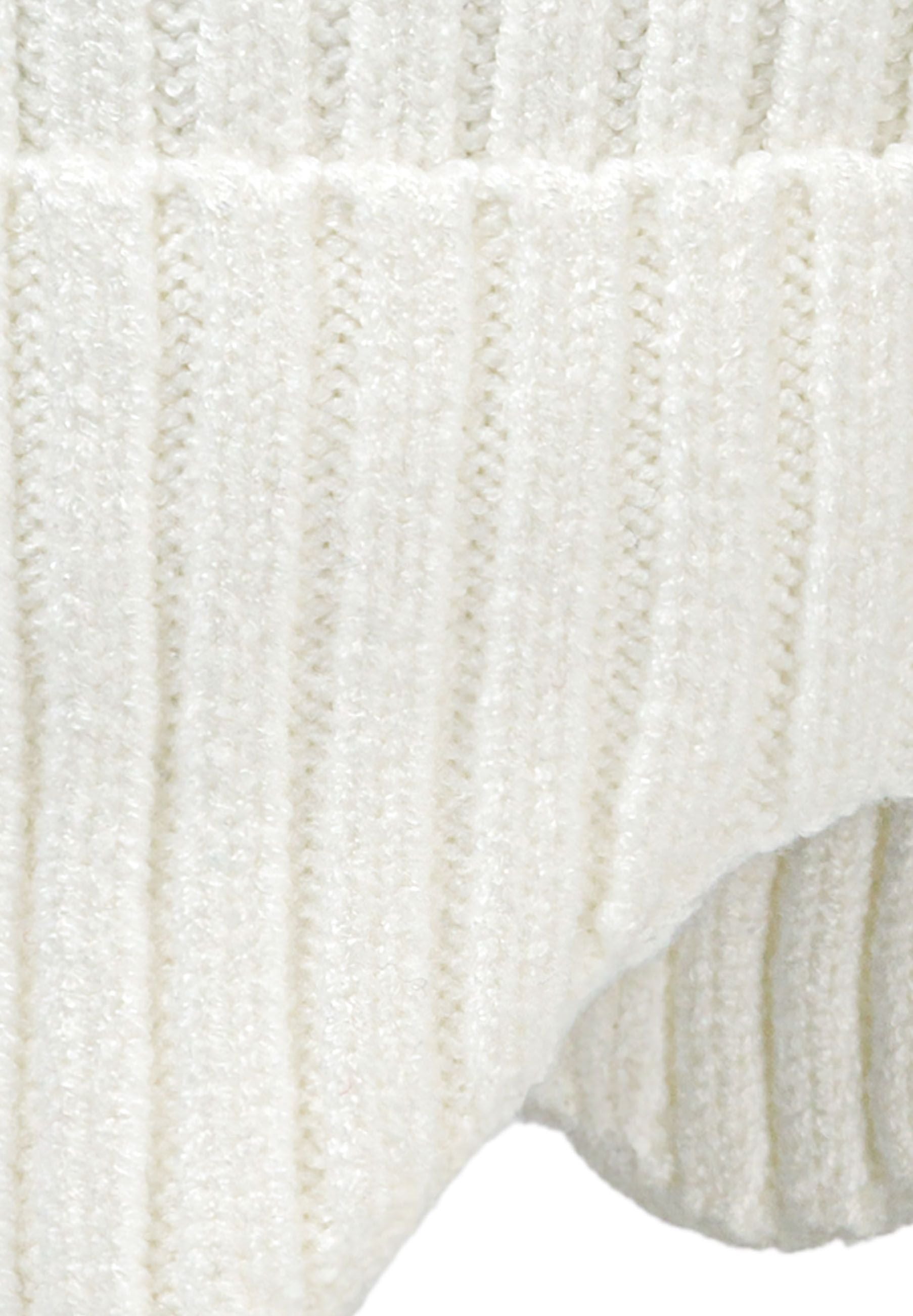 Detail of cream ribbed knit hat with extended ear flaps and pompom.