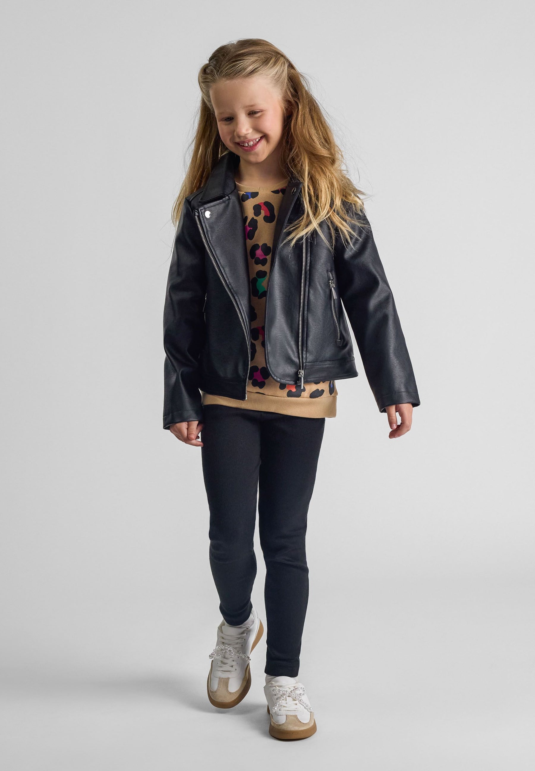 Girls biker jacket in black, front view with silver zip and lapel collar.