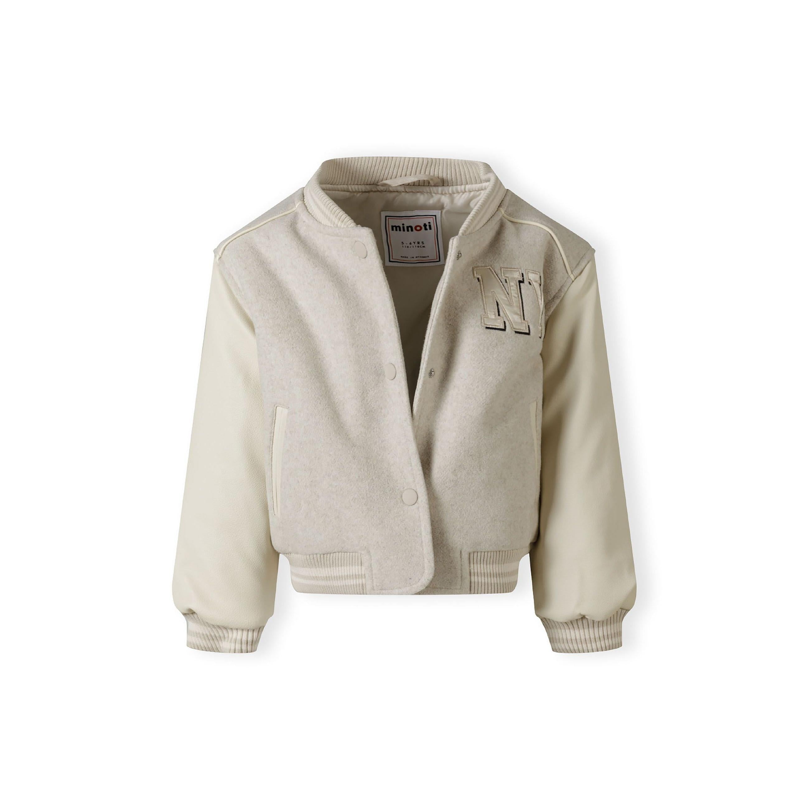 Close-up detail of side pocket on beige baseball jacket showing piped trim and quality construction