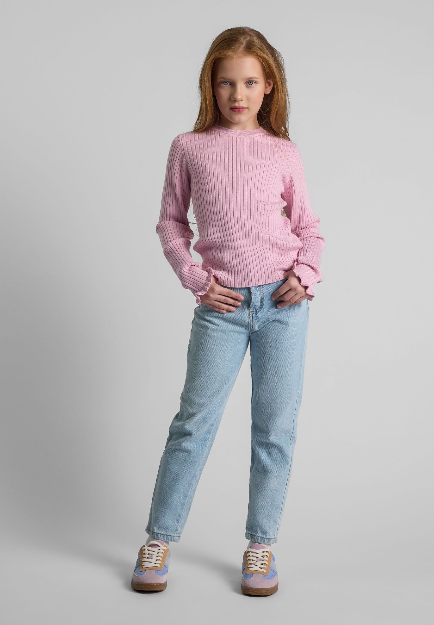 Girls ribbed long sleeve jumper in light pink with frilled cuffs, front view.