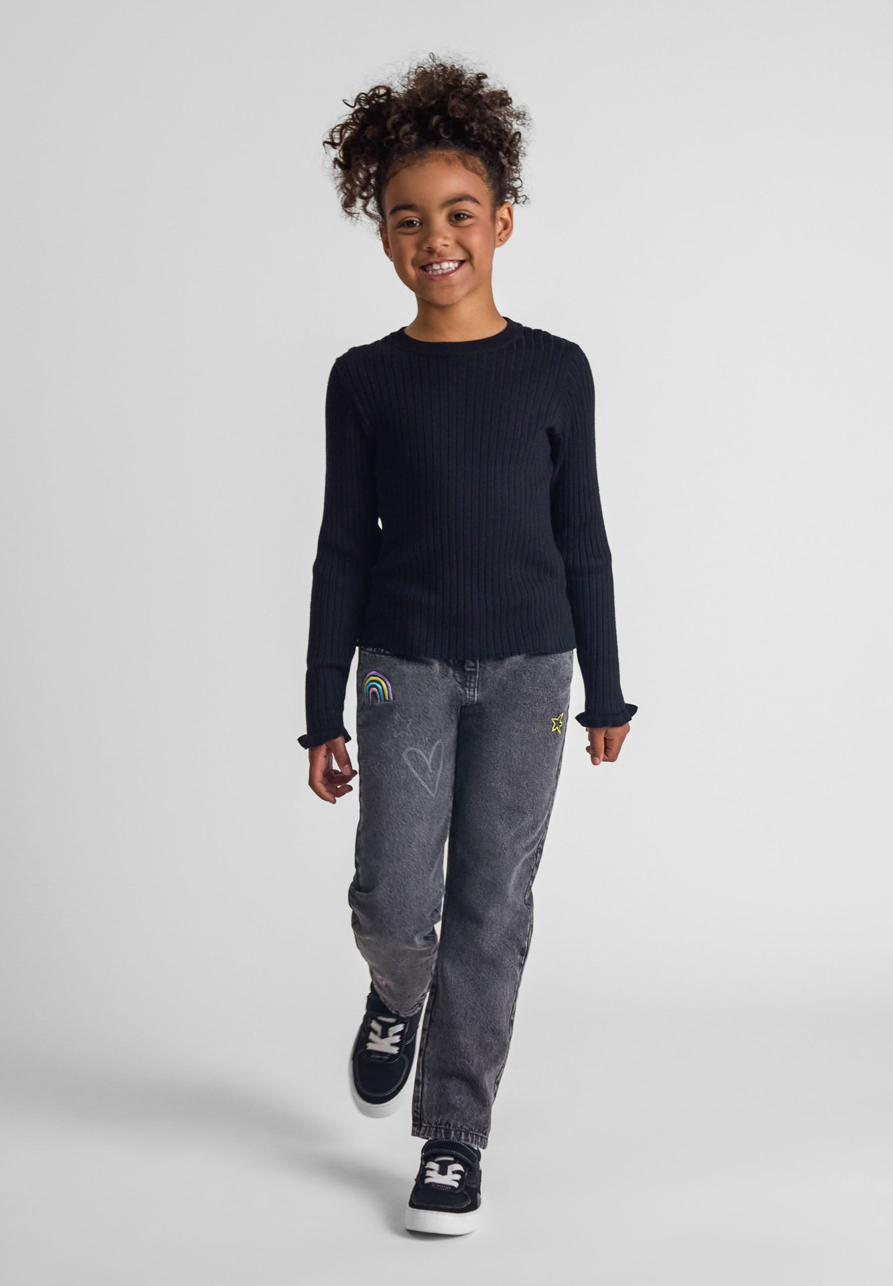 Girls black embroidered jeans with elasticated waist, front view.