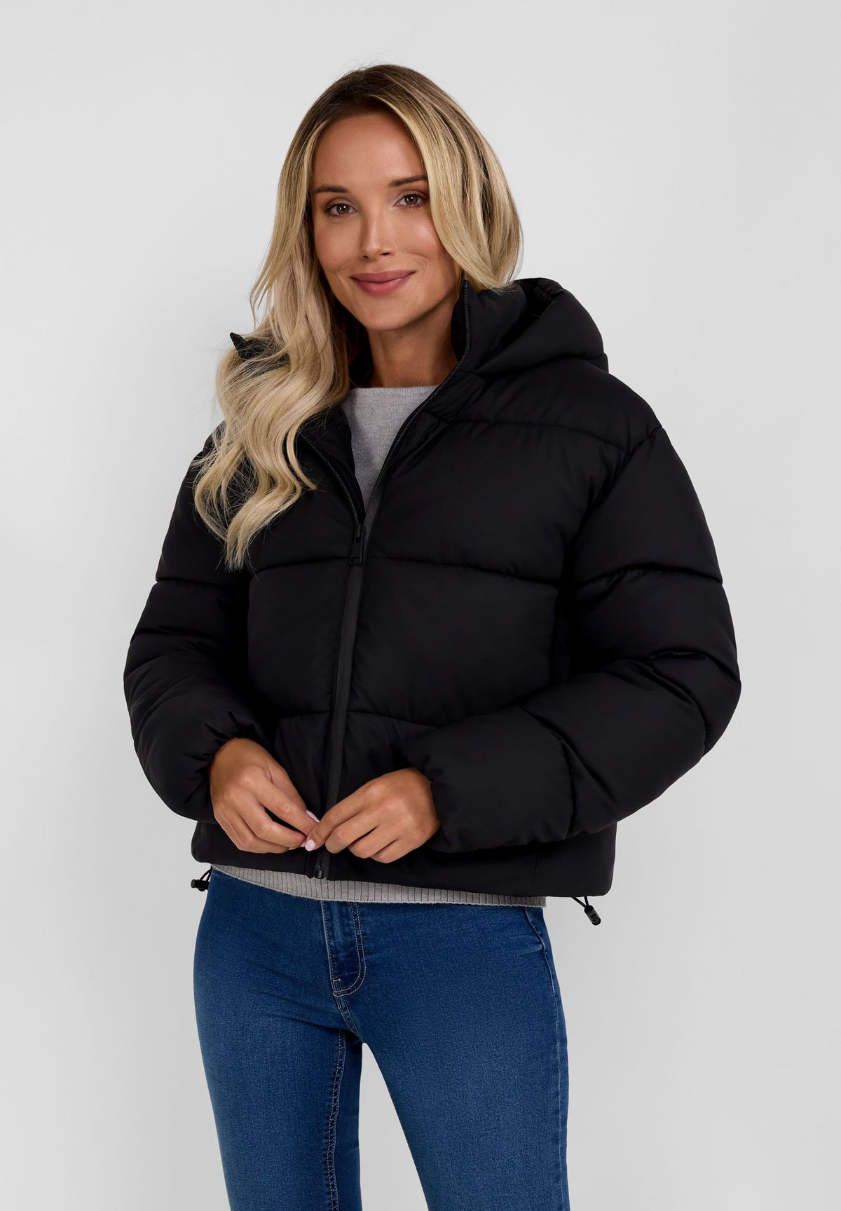 Women's black cropped puffer jacket, shown worn.