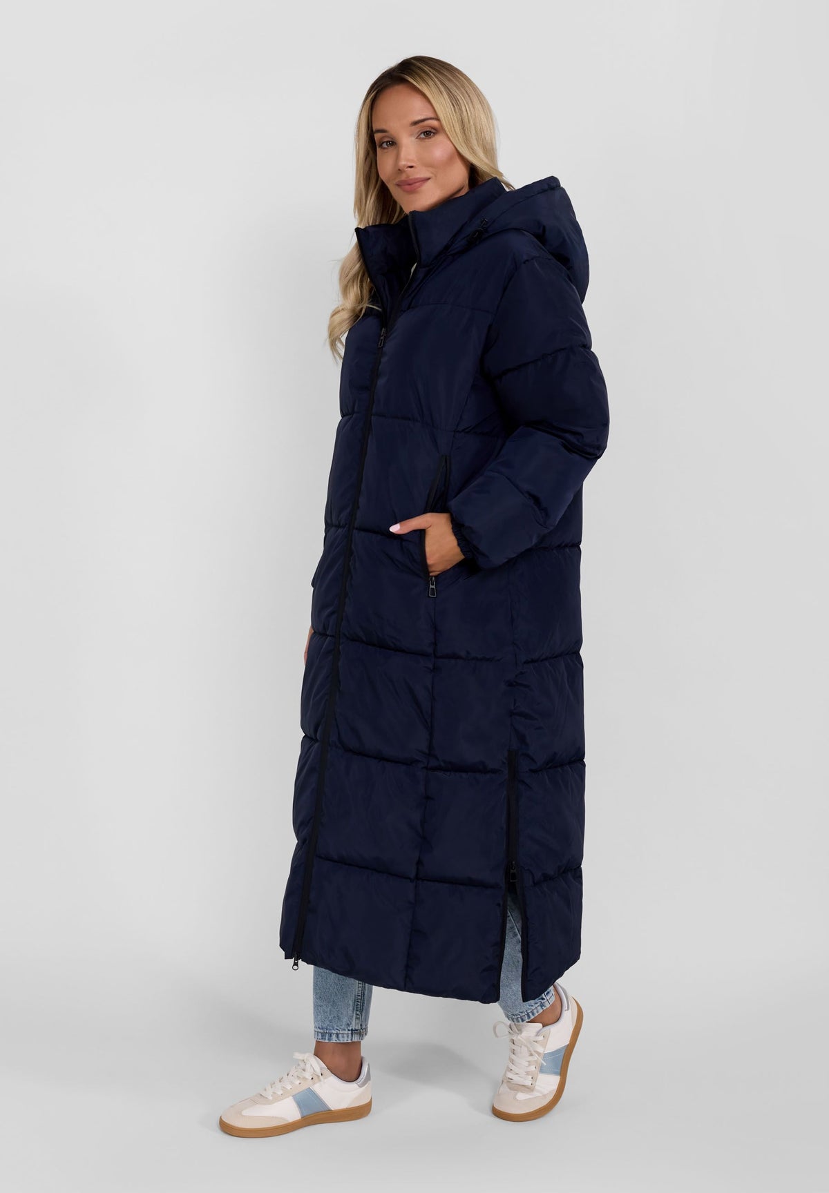 Women's navy long puffer coat, shown worn.