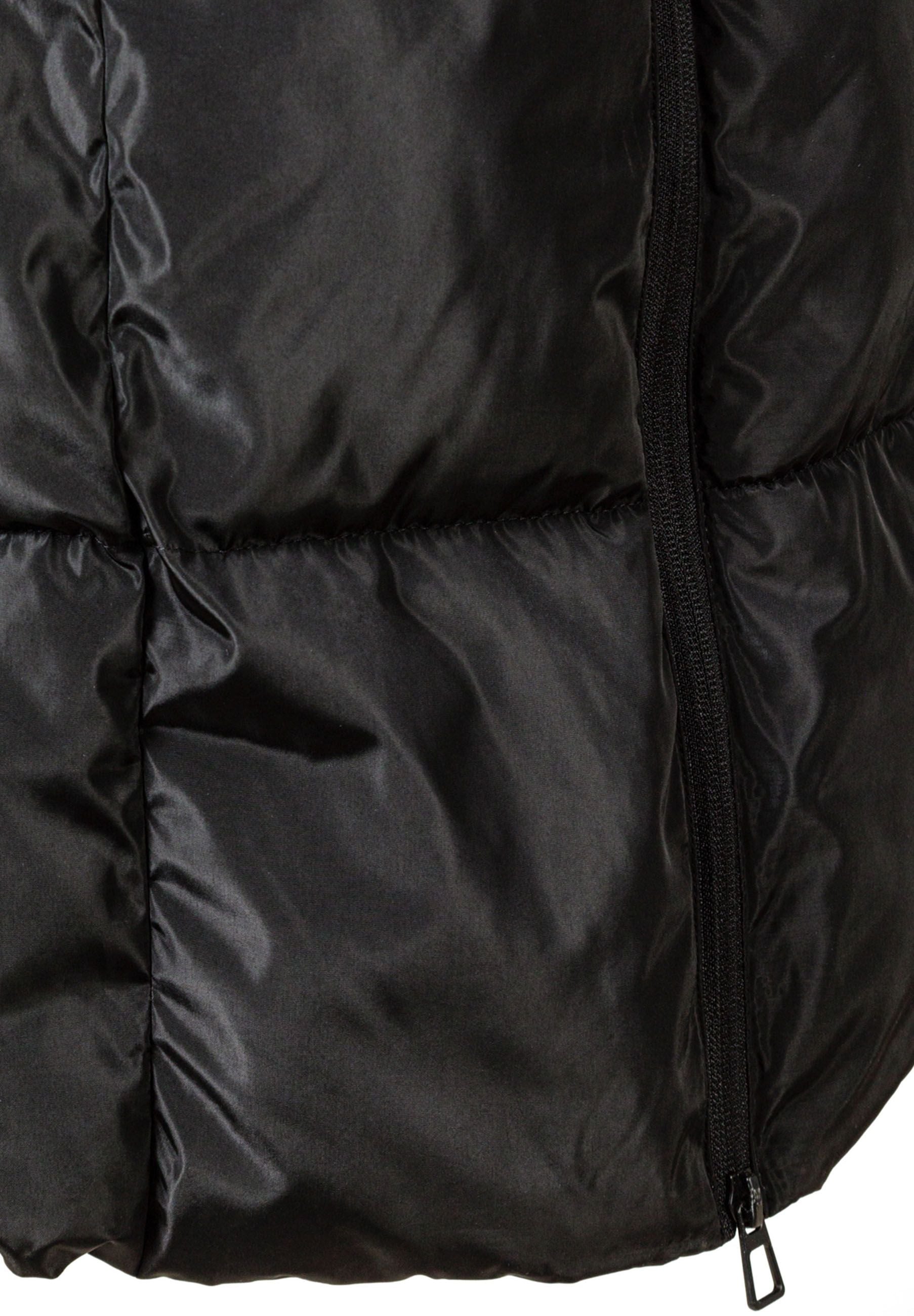 Detail of a black quilted winter jacket with a zipper and padded sections.
