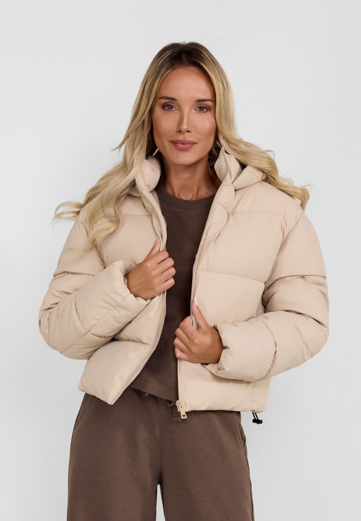 Women's beige cropped puffer jacket, shown worn.